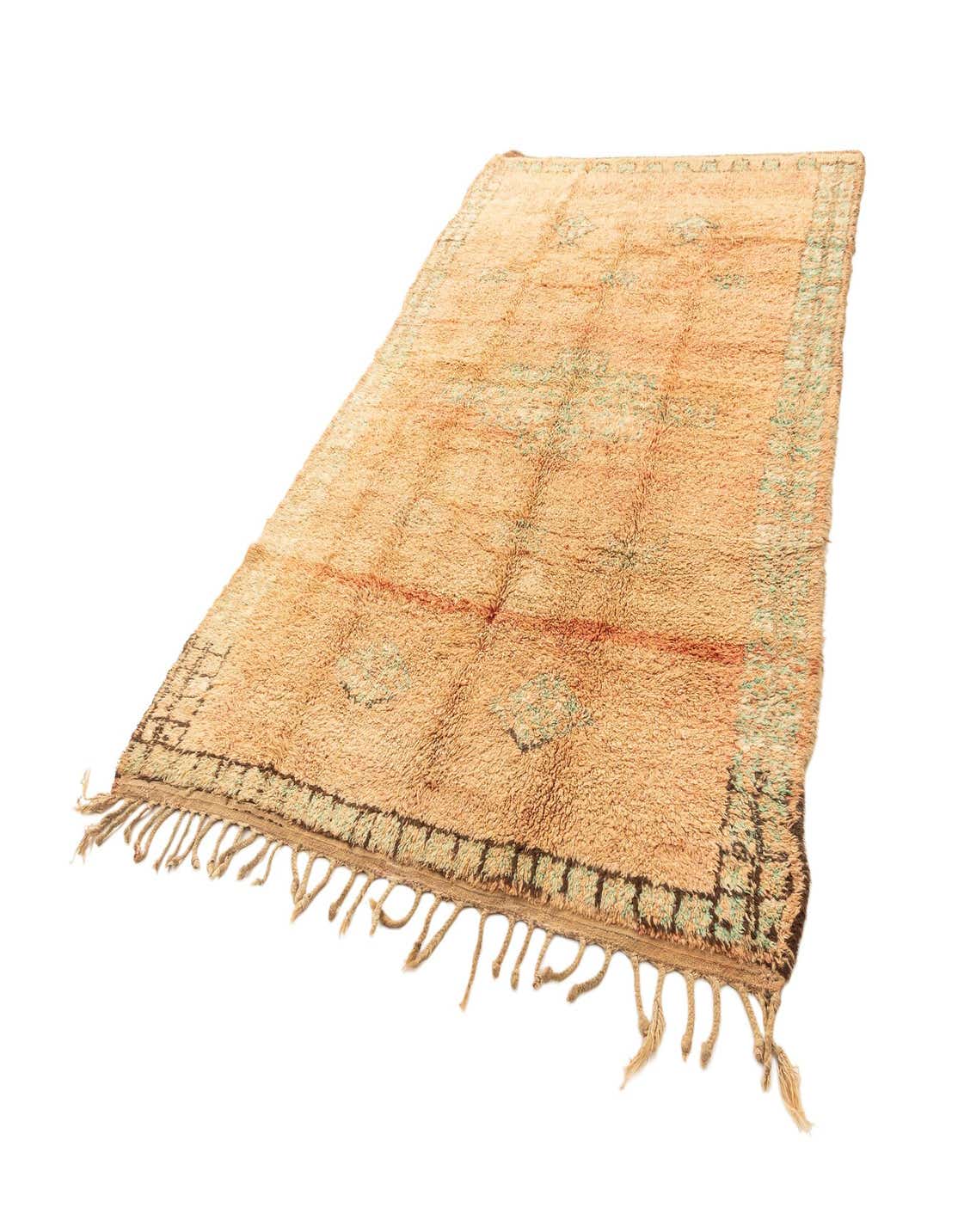 A 6x9 rectangular orange wool area rug with a medium pile and fringed edges, featuring subtle geometric patterns in muted tones.