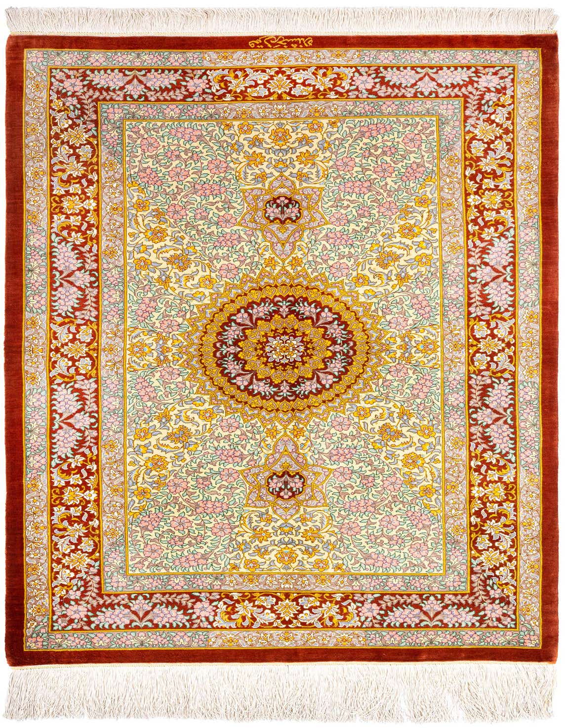 A rectangular 3x4 Ghom Silk Persian rug featuring a central medallion and intricate floral patterns in orange, pink, and yellow on a cream background, with a rich orange border and white fringe.