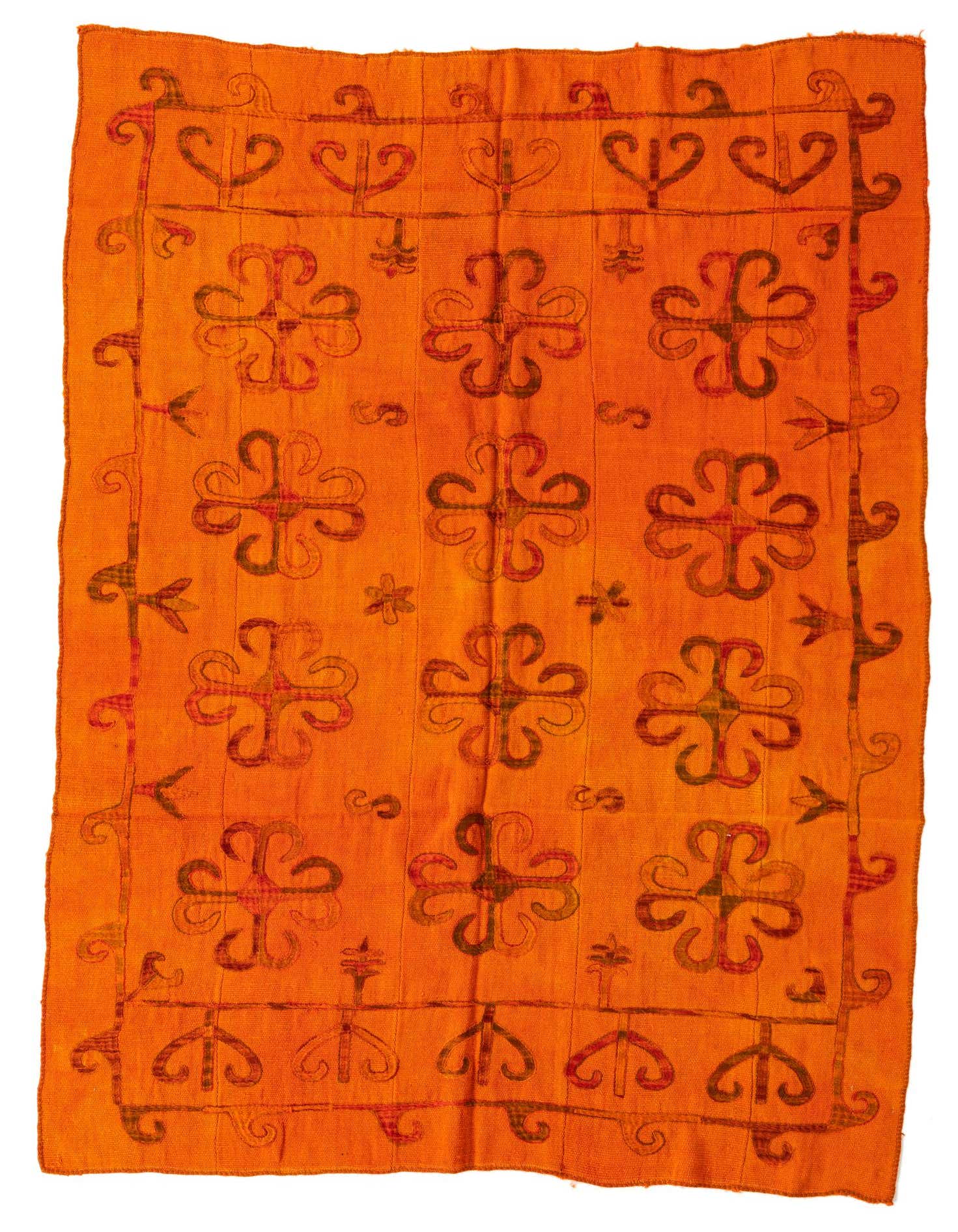 A 5x8 rectangular orange tribal flatweave rug with a repeating pattern of dark orange and red stylized floral motifs.