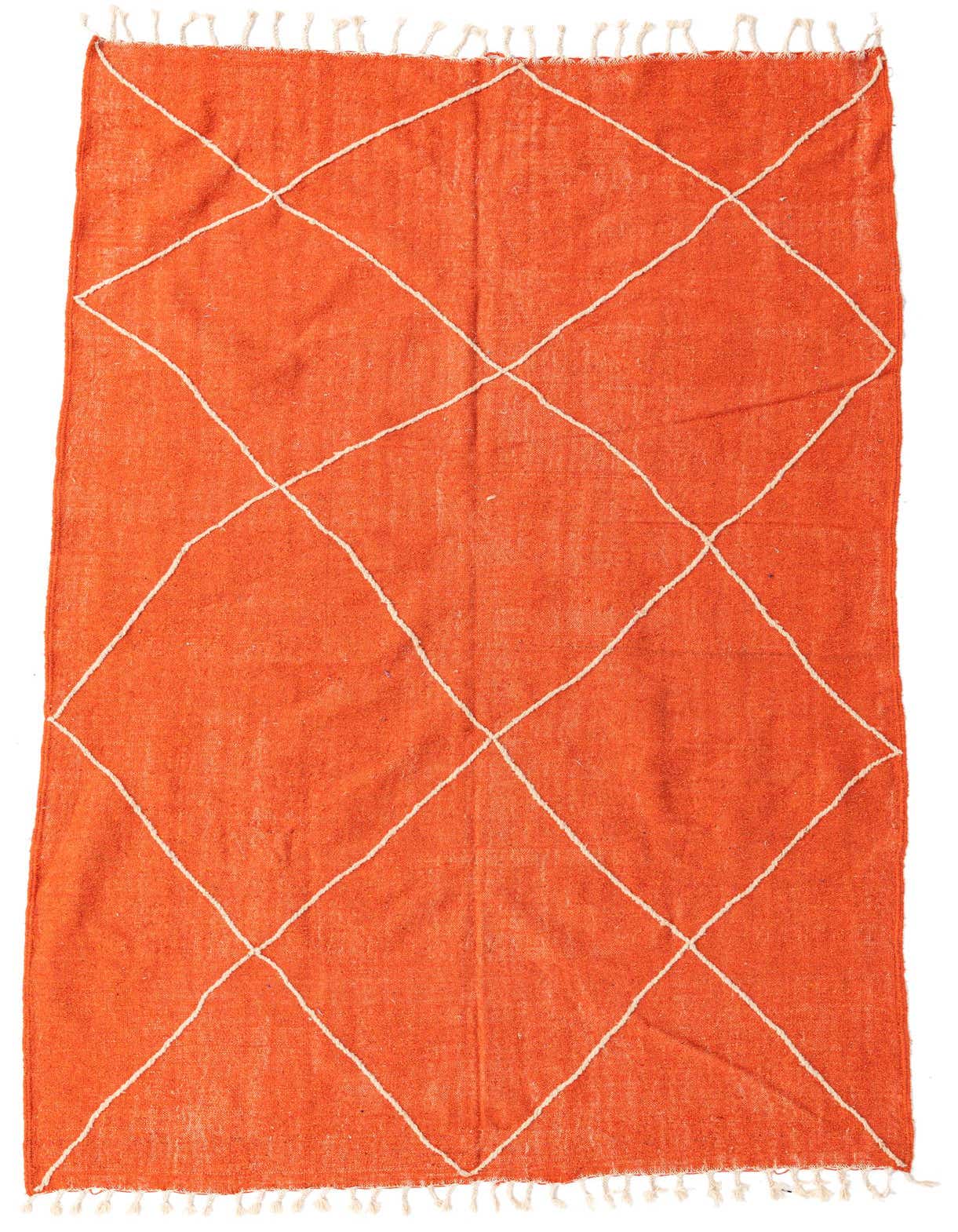 A 7x10 rectangular orange wool shag rug with a white tribal diamond pattern and fringe.