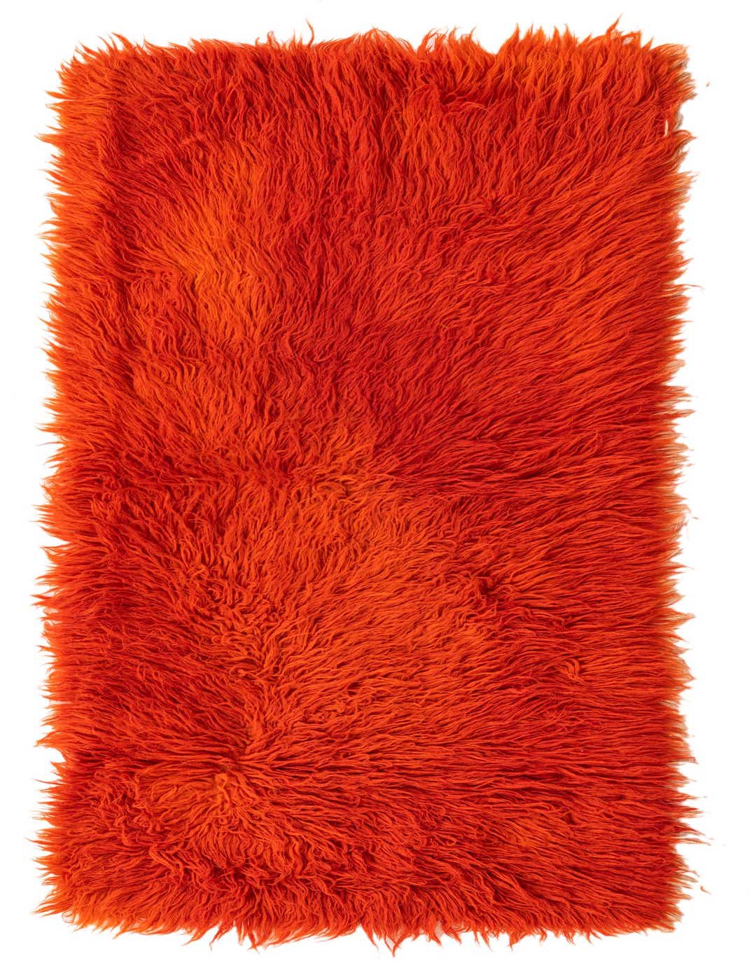 A vibrant 3x5 rectangular orange shag wool rug with a thick, plush pile, perfect for adding warmth and texture to an indoor space.