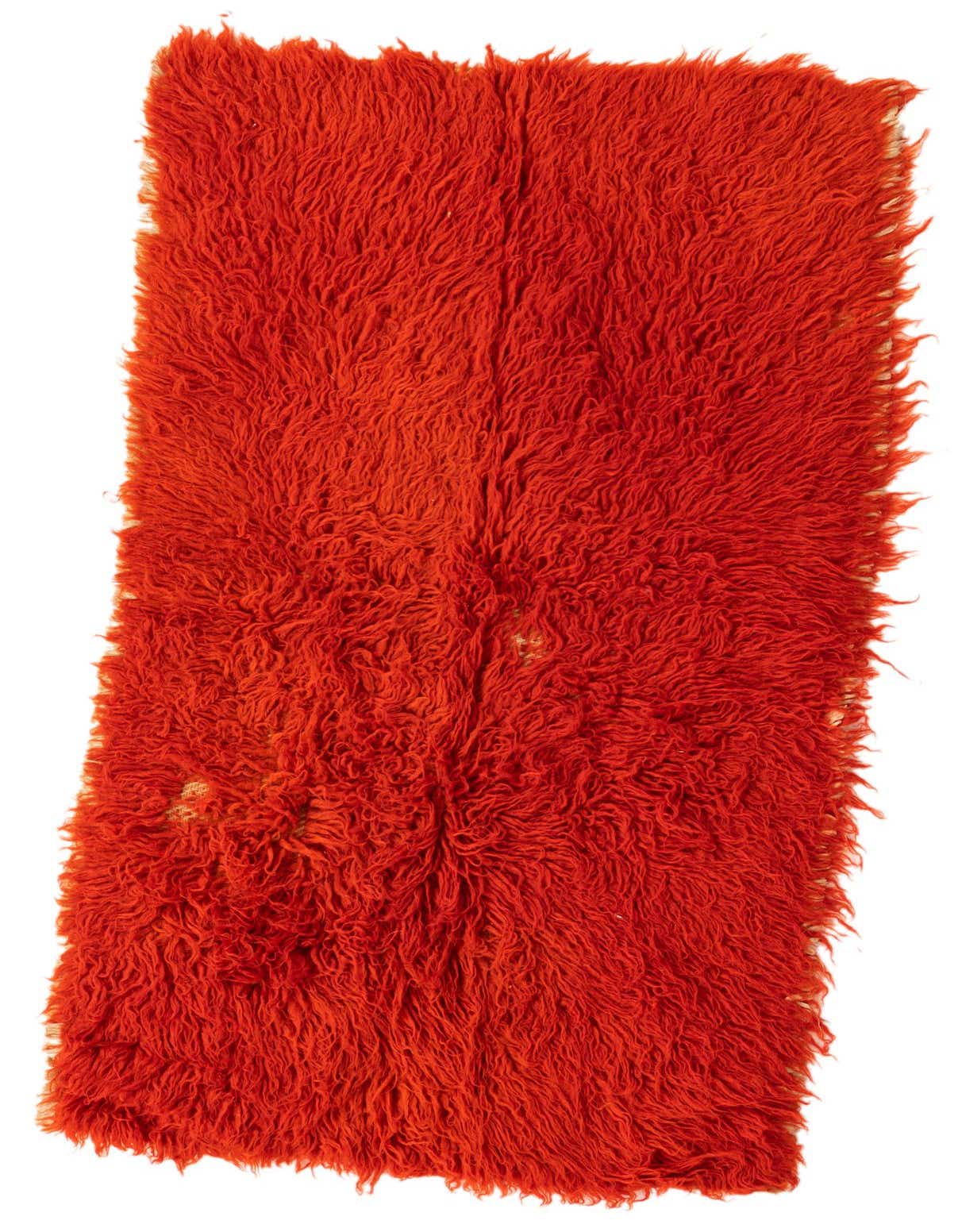A vibrant orange 3x4 rectangular shag rug with a thick, plush pile, showcasing its handmade texture.