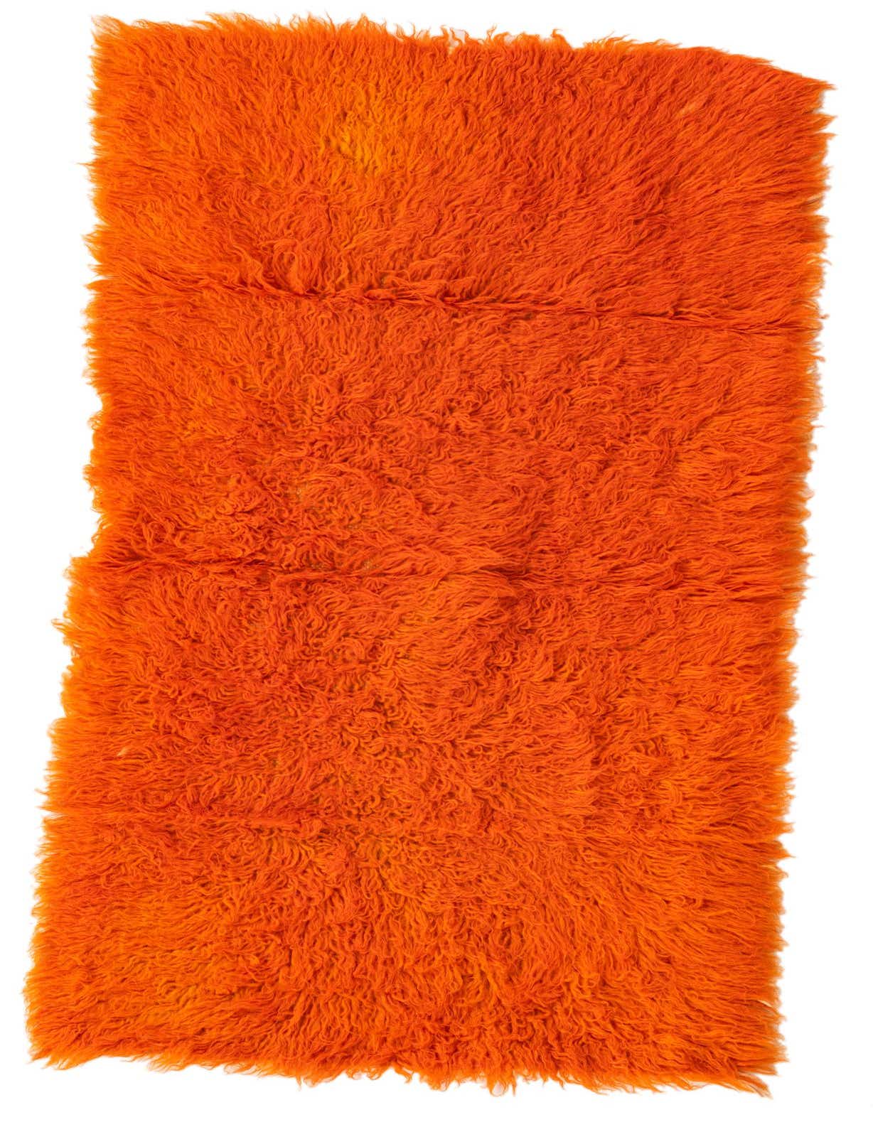 A vibrant 3x5 rectangular orange shag rug, handmade from wool, featuring a plush, textured pile.