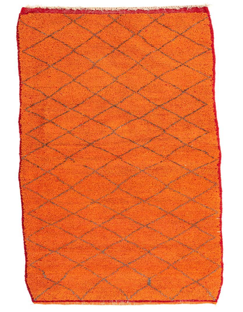 A vibrant orange 9 ft runner rug with a gray tribal diamond pattern and shag pile, ideal for hallways.