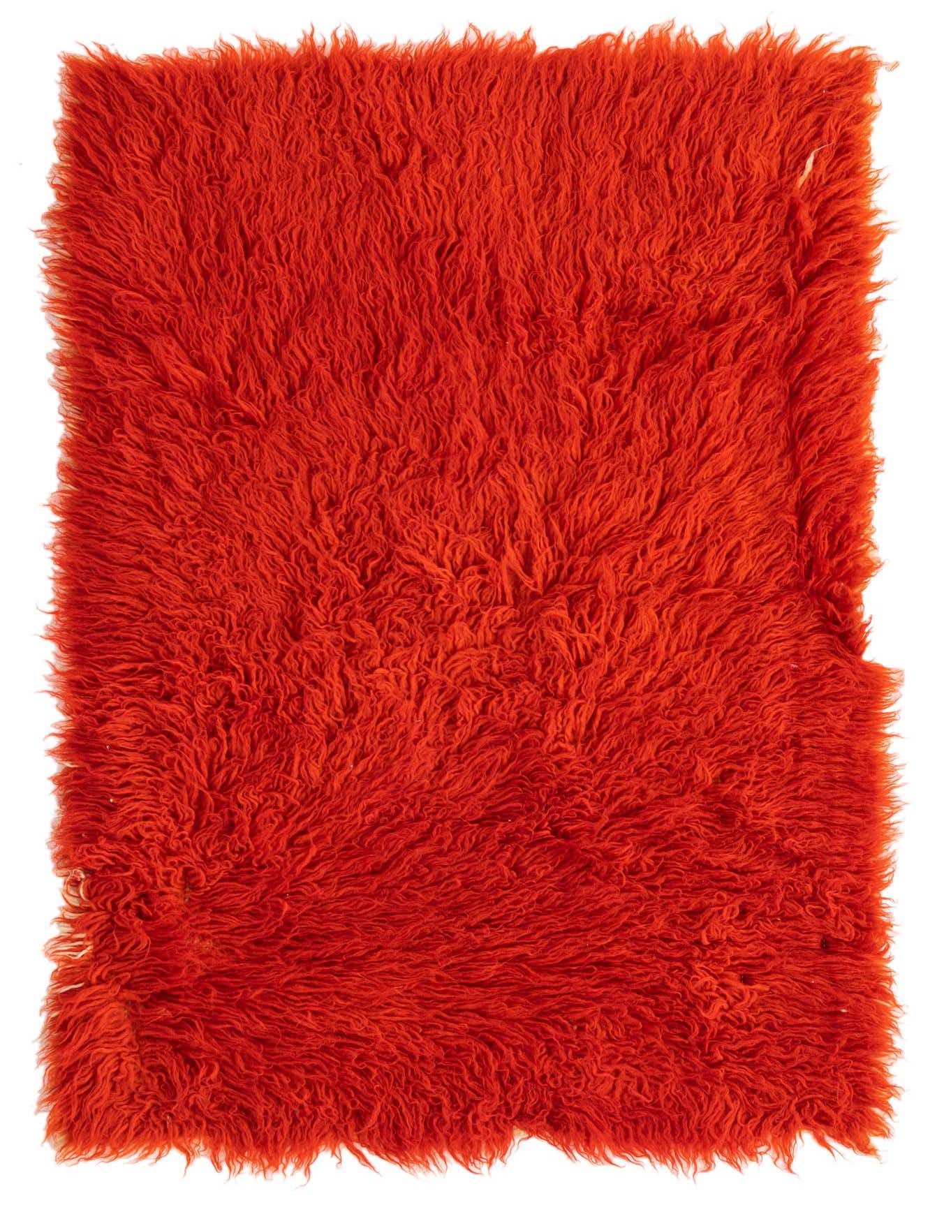 A vibrant orange 4 ft runner rug with a plush shag pile, handmade from 100% wool, perfect for a hallway.