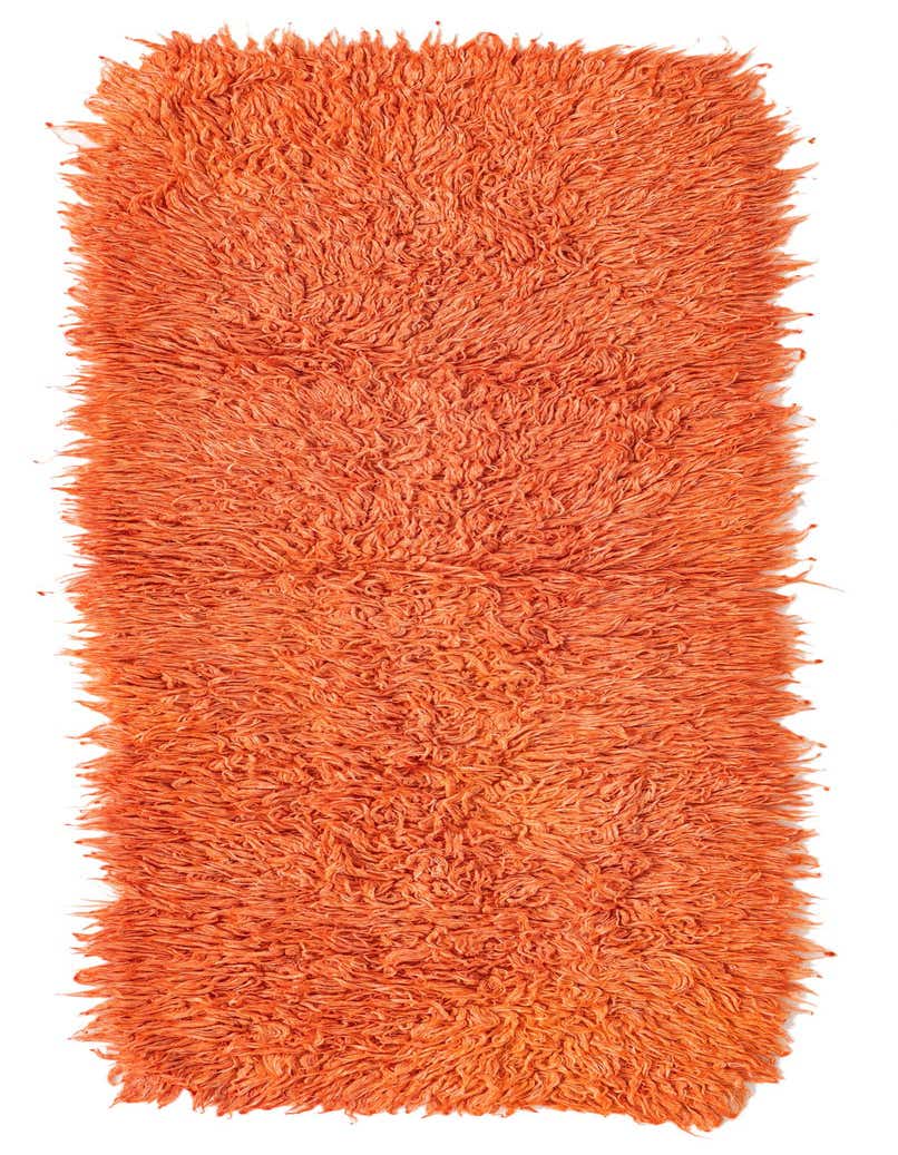 A vibrant orange shag runner rug, 7 ft long, with a plush, textured pile, ideal for a hallway.