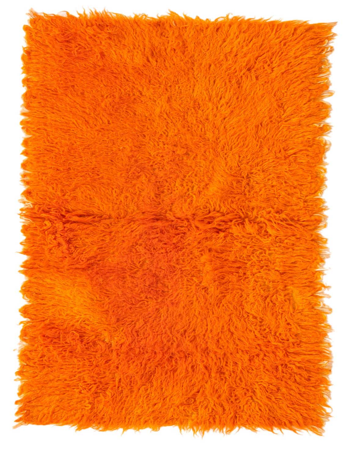 A vibrant orange shag runner rug, handmade from wool, featuring a plush, high pile texture.