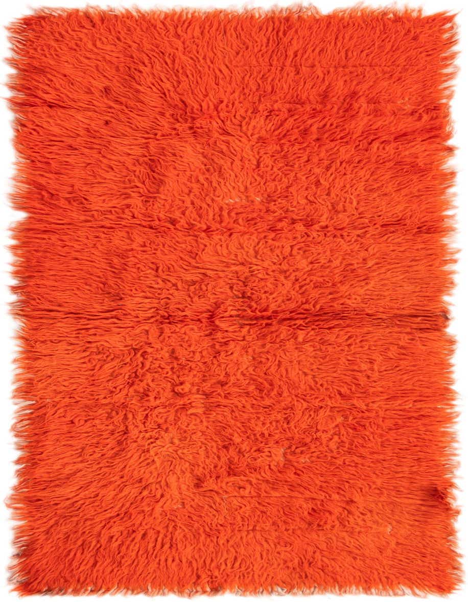 A vibrant orange 4 ft runner rug with a plush shag pile, handmade from 100% wool.