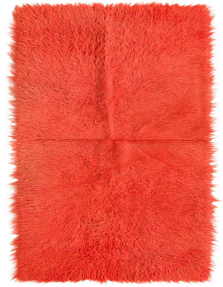 A vibrant orange 6 ft runner rug with a plush shag pile, handmade from wool, perfect for a hallway.