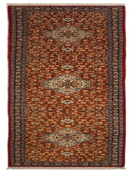 A 12 ft runner rug in a rich orange hue featuring an intricate traditional Persian pattern with floral motifs and a detailed border.