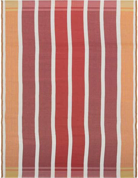 A 12 ft runner rug with bold vertical stripes in shades of orange, pink, and white, suitable for a hallway or patio.