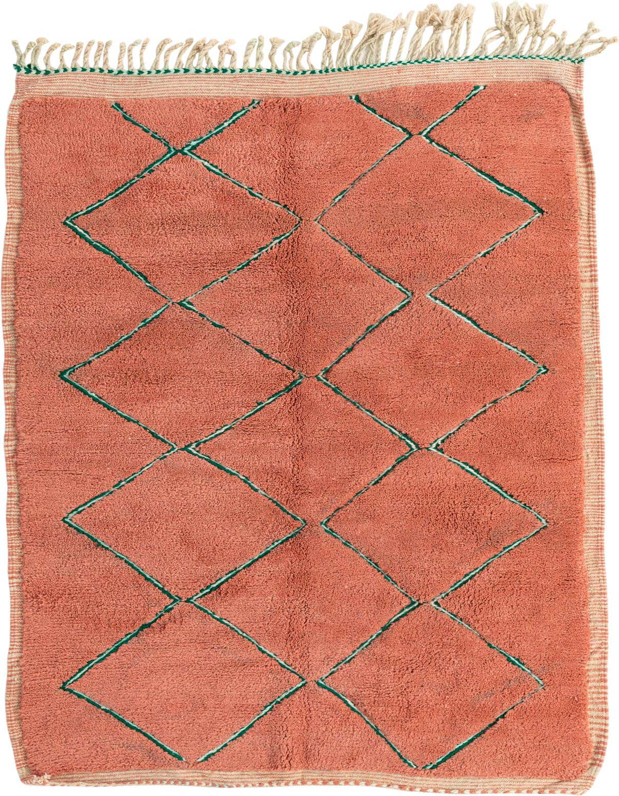 A 5x8 rectangular orange shag rug with a green tribal diamond pattern and fringed ends, suitable for a living room.