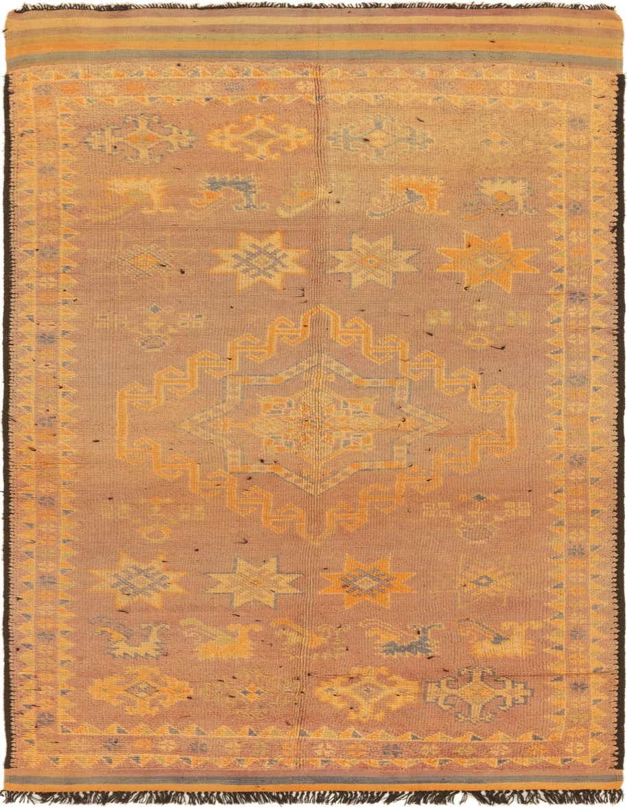 A 14 ft runner rug in shades of orange and brown, featuring a central medallion and scattered tribal patterns.