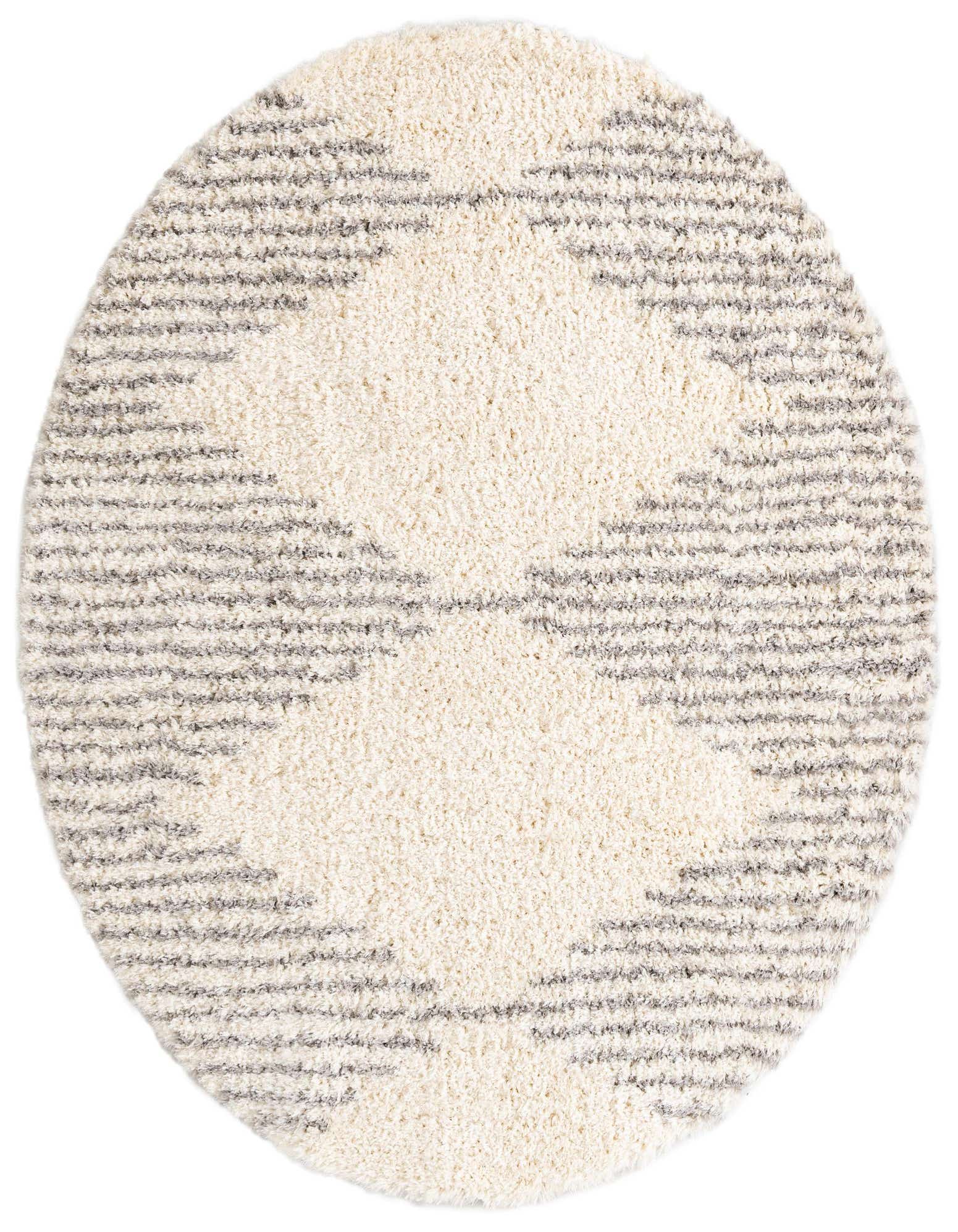 A round, gray and ivory modern shag rug with a central diamond pattern, suitable for a living room or bedroom.