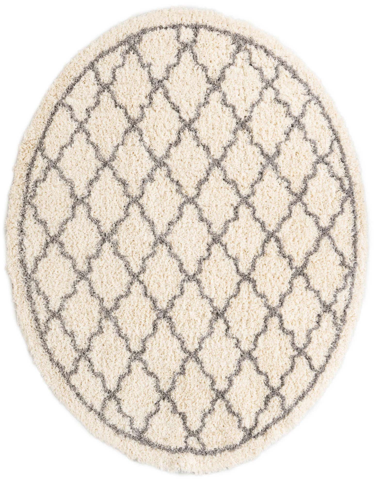 A round, cream-colored shag rug with a modern gray geometric trellis pattern, perfect for adding texture to a living room.