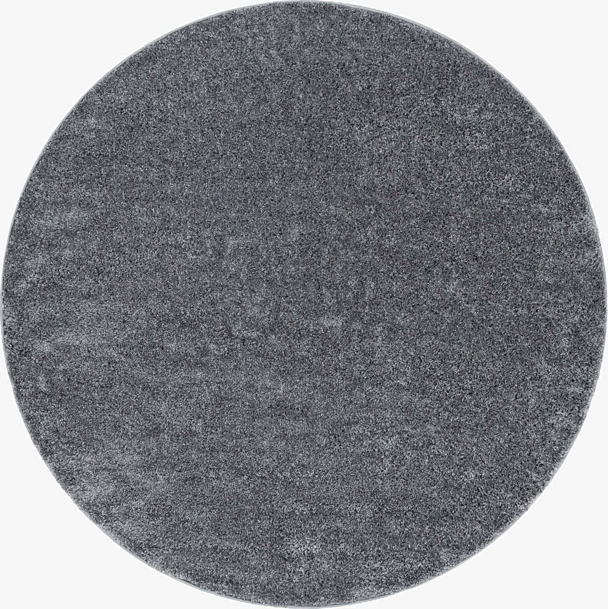 A 3' 3 round gray shag rug with a textured pile, suitable for modern or minimalist indoor spaces.