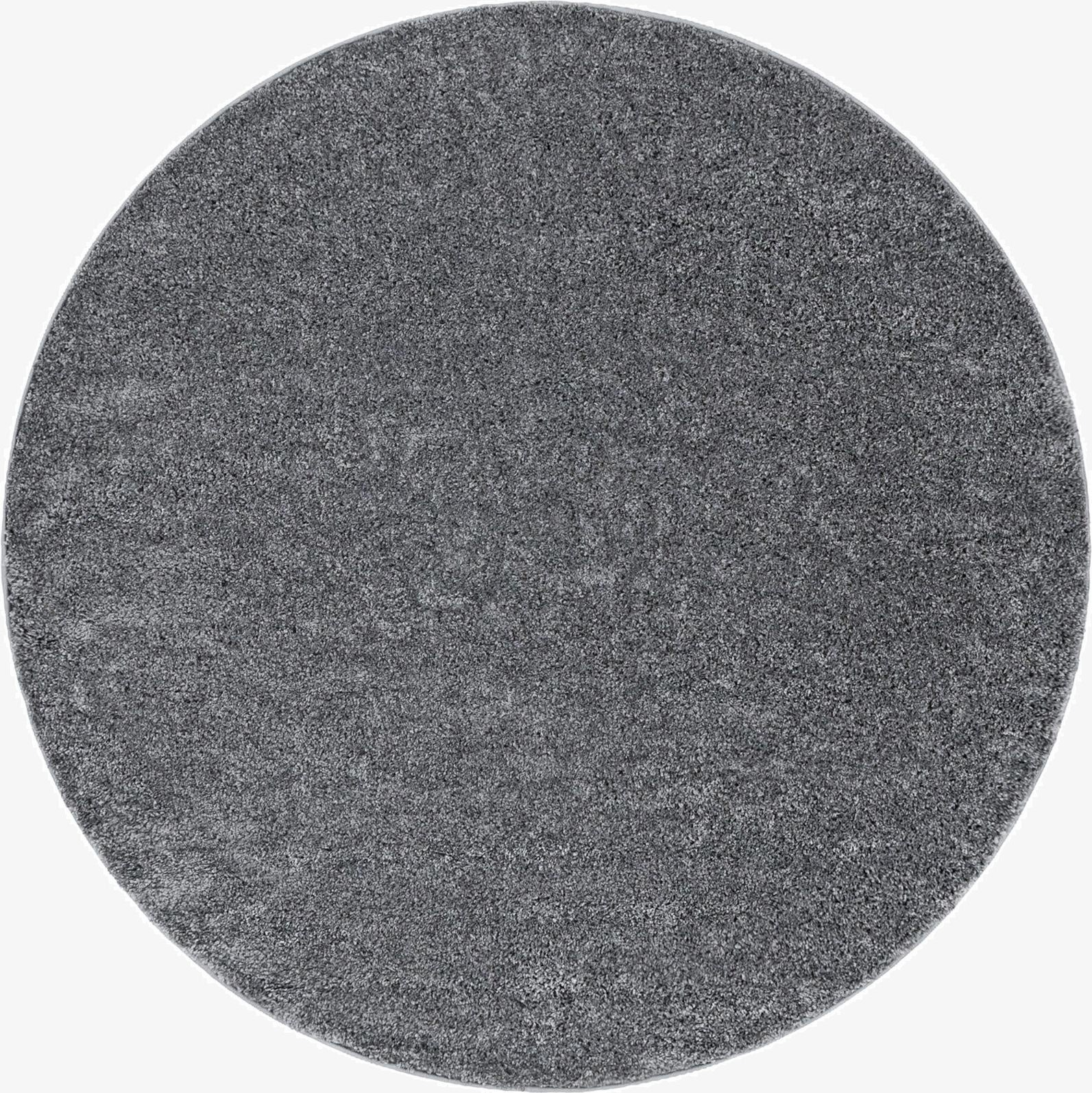 A 4' round gray shag rug with a textured pile, perfect for adding softness to any indoor space.