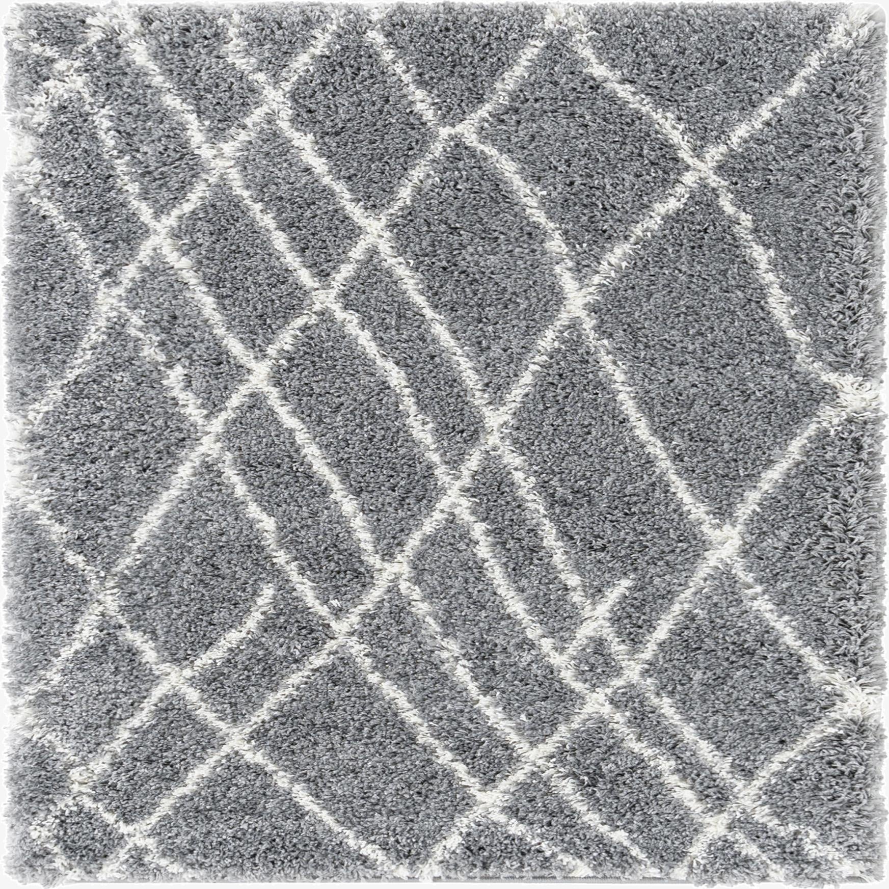 A gray shag area rug with a white geometric diamond pattern, featuring a soft, textured pile.
