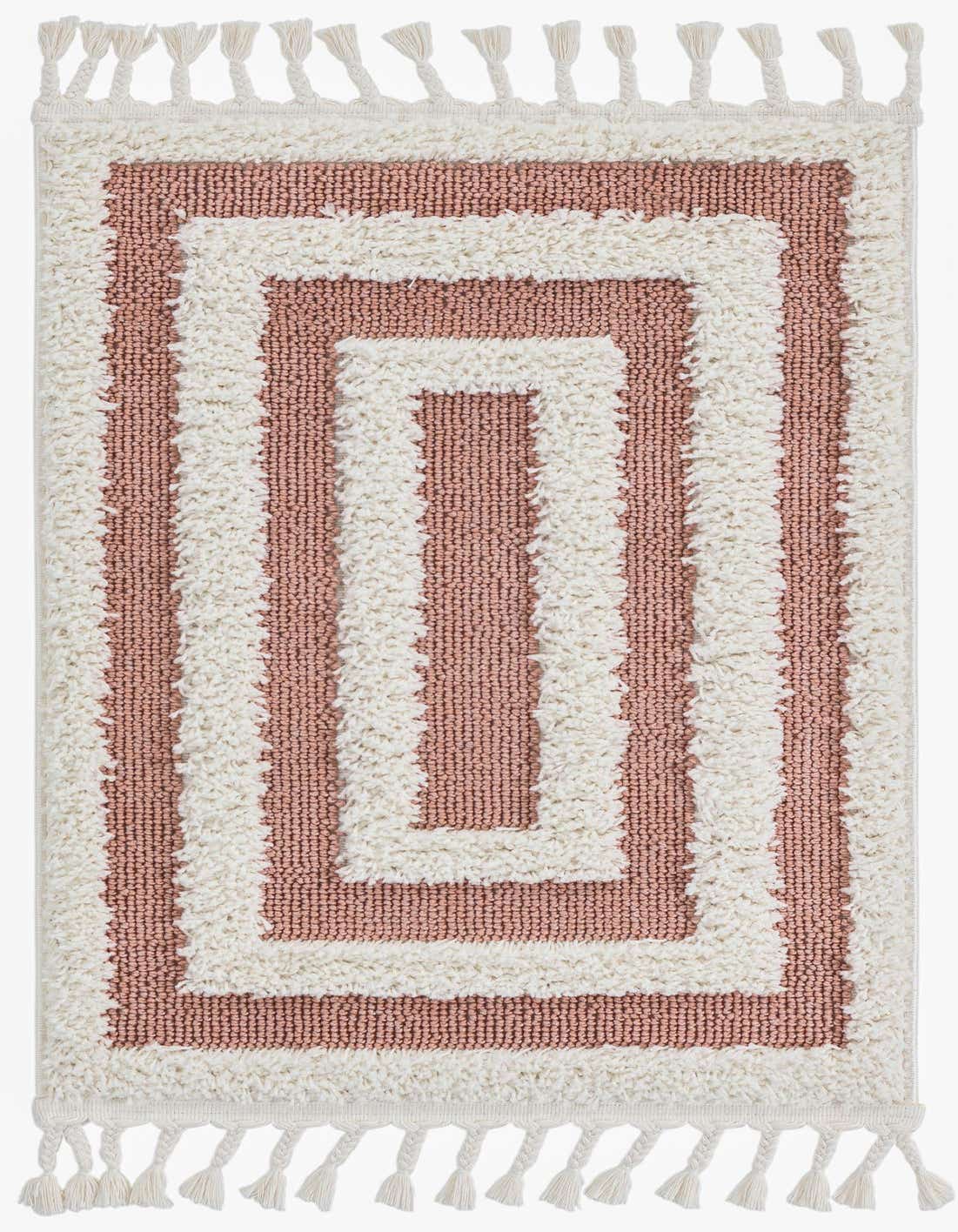 A 2x3 rectangular indoor rug with a modern stripe pattern in pink and off-white, featuring a textured high pile and decorative tassels.