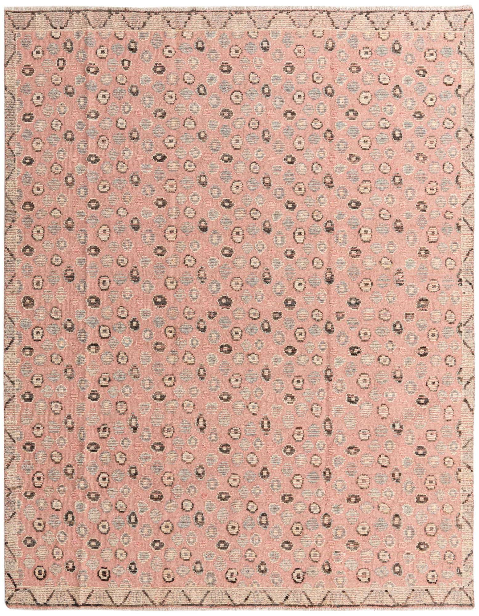 A rectangular 8x10 pink wool rug with a modern abstract pattern of grey, beige, and black circles, featuring a geometric border.