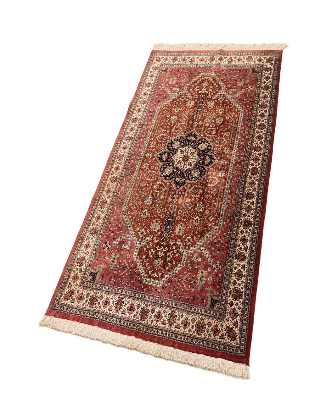 A 4x6 rectangular Ghom Silk rug in shades of pink, featuring an intricate traditional medallion pattern with fringes.