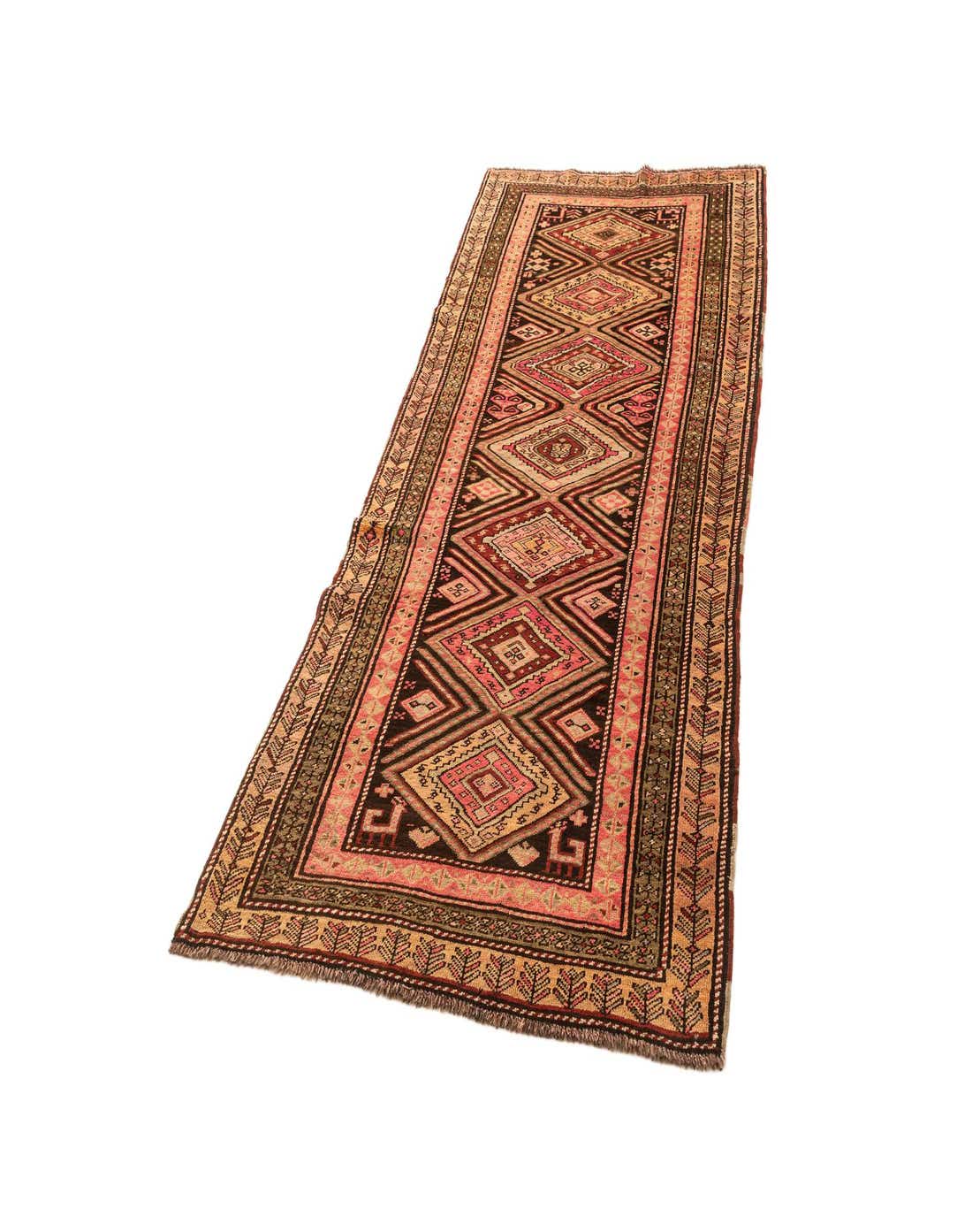 A 4x6 rectangular indoor rug with a traditional geometric pattern in shades of pink, brown, and cream.