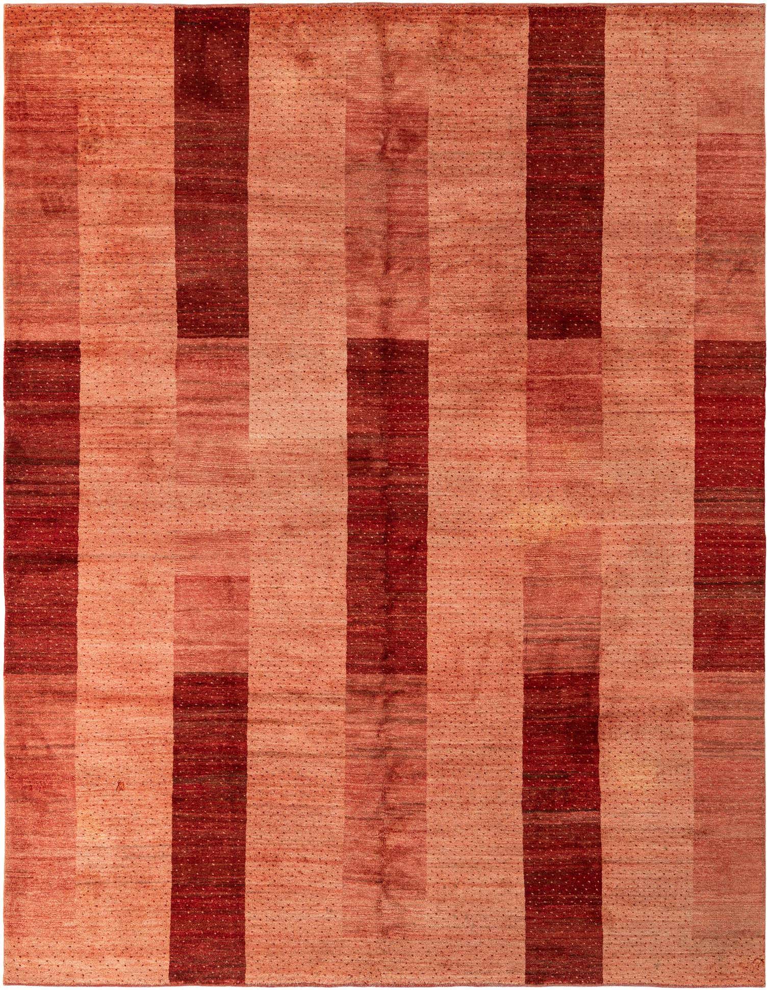 A 6x9 rectangular Indo Gabbeh wool rug featuring a modern abstract pattern of varying pink and red vertical stripes.