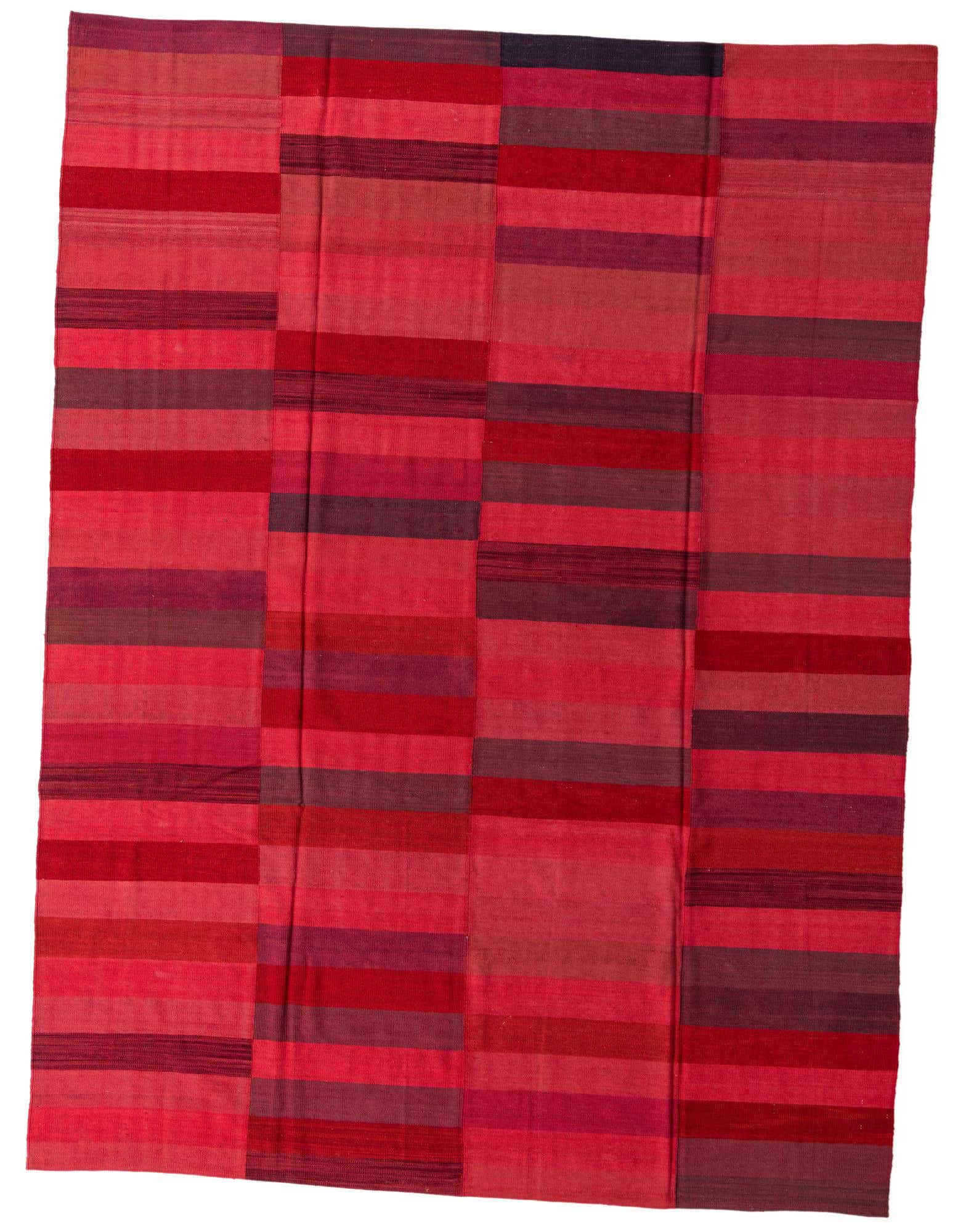 An 8x11 rectangular Kilim Modern rug with a vibrant striped pattern in various shades of pink and red, suitable for a living room.