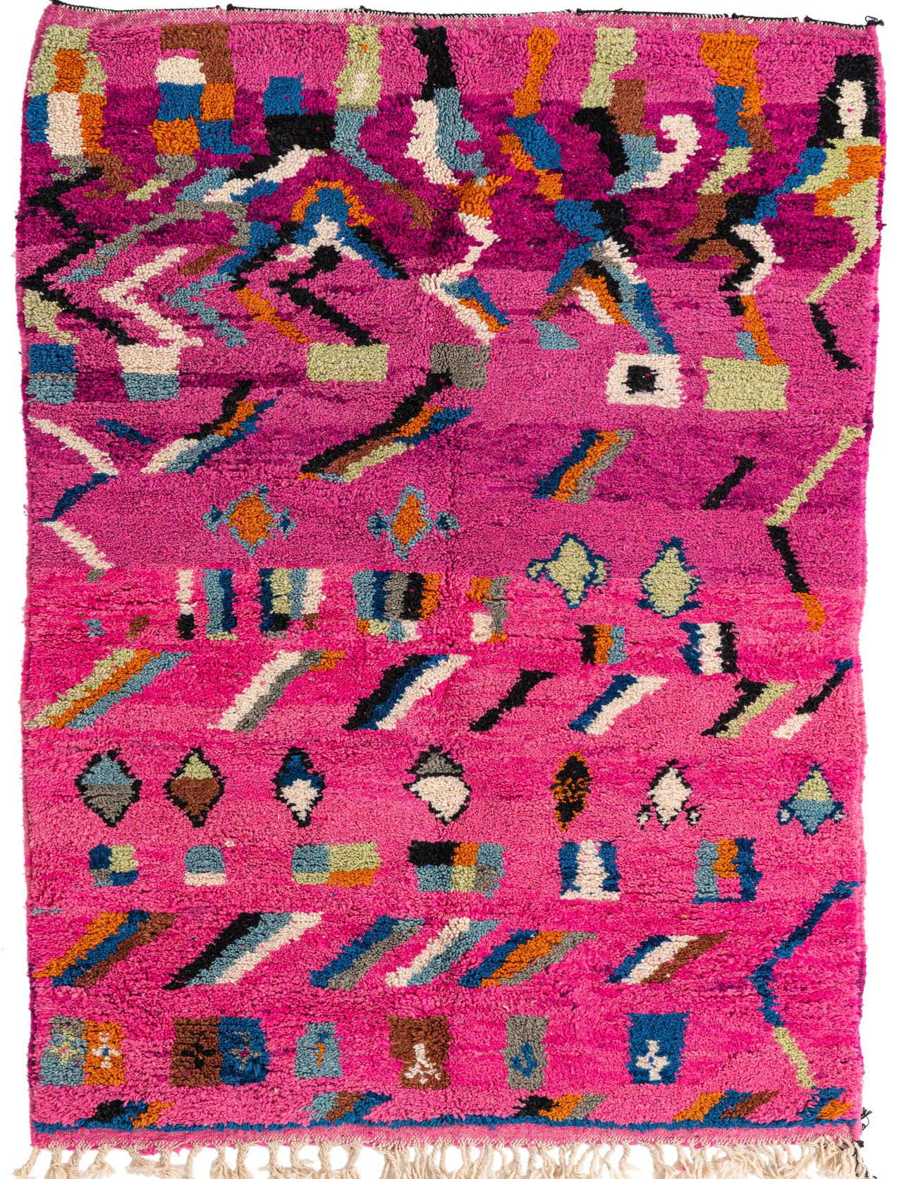 A vibrant 5x8 rectangular shag rug with a fuchsia pink background and colorful abstract tribal patterns in blues, oranges, greens, and black.
