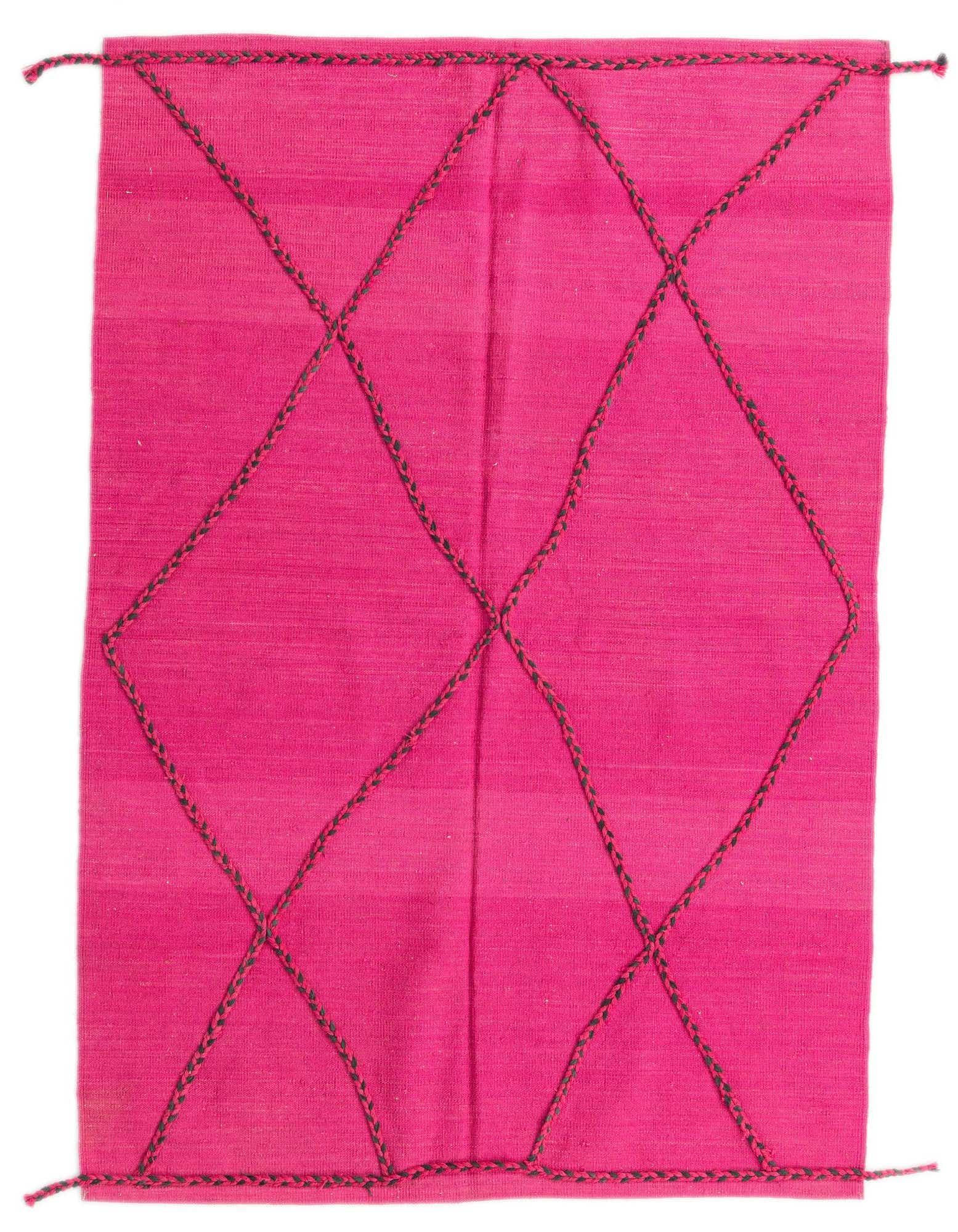 A vibrant 4x6 rectangular pink wool shag rug featuring a bold black tribal diamond pattern, perfect for a modern living room.