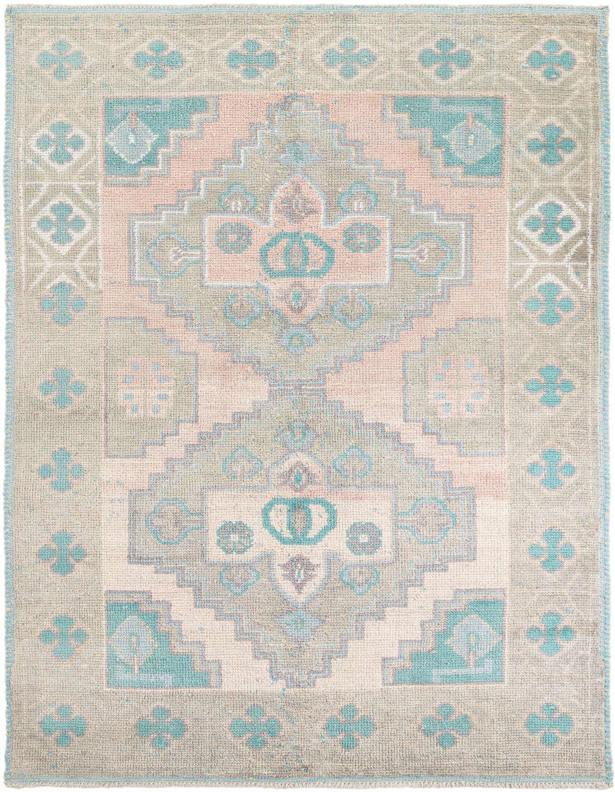 A 6x9 rectangular Moroccan shag rug in pinks, teal, and gray with a tribal medallion pattern, ideal for a living room.