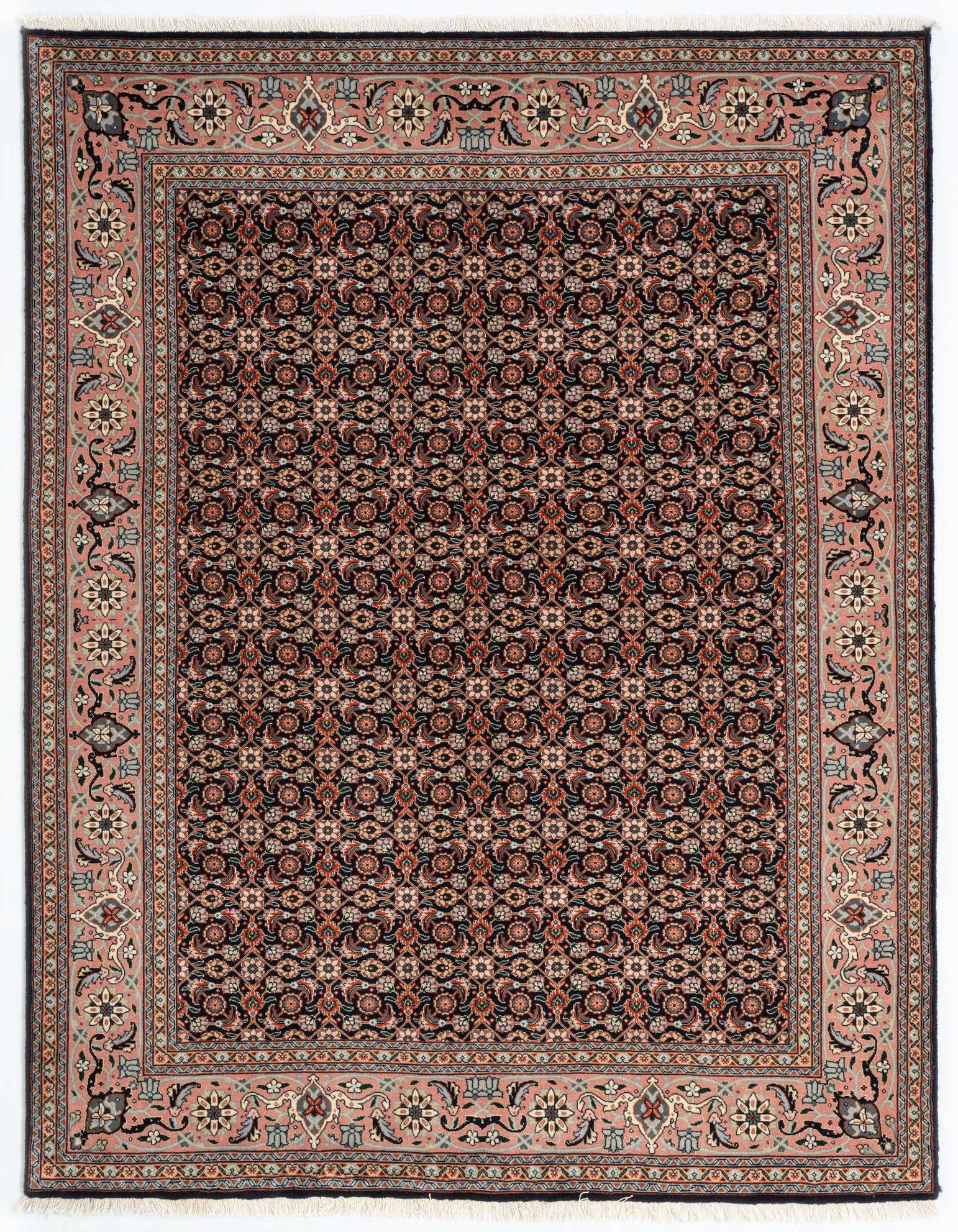 A 4x6 rectangular Persian rug with a dark field and intricate floral patterns, framed by a wide pink border with complementary motifs.