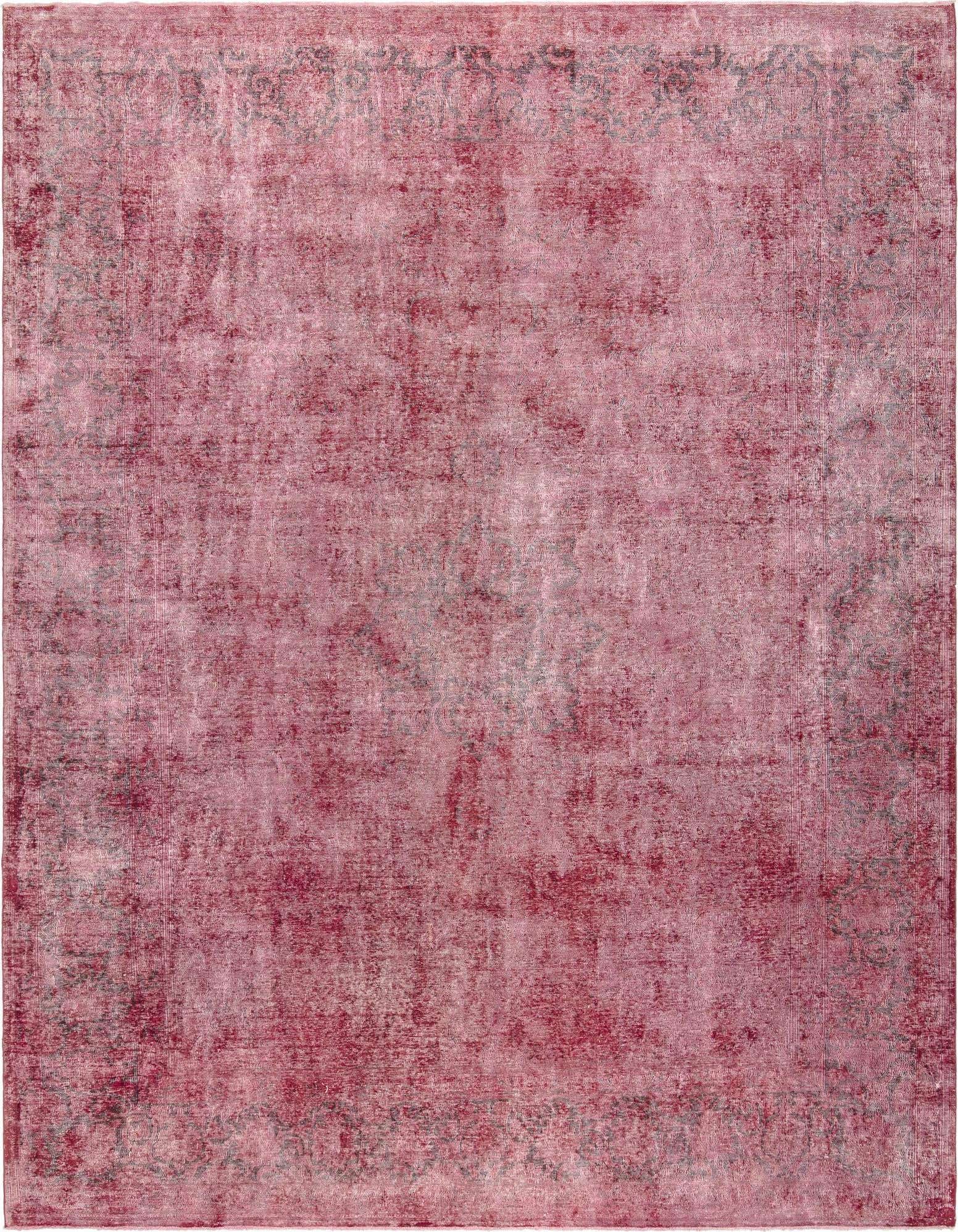 A 10x13 rectangular pink Persian wool rug with a distressed, vintage look and subtle gray patterns.