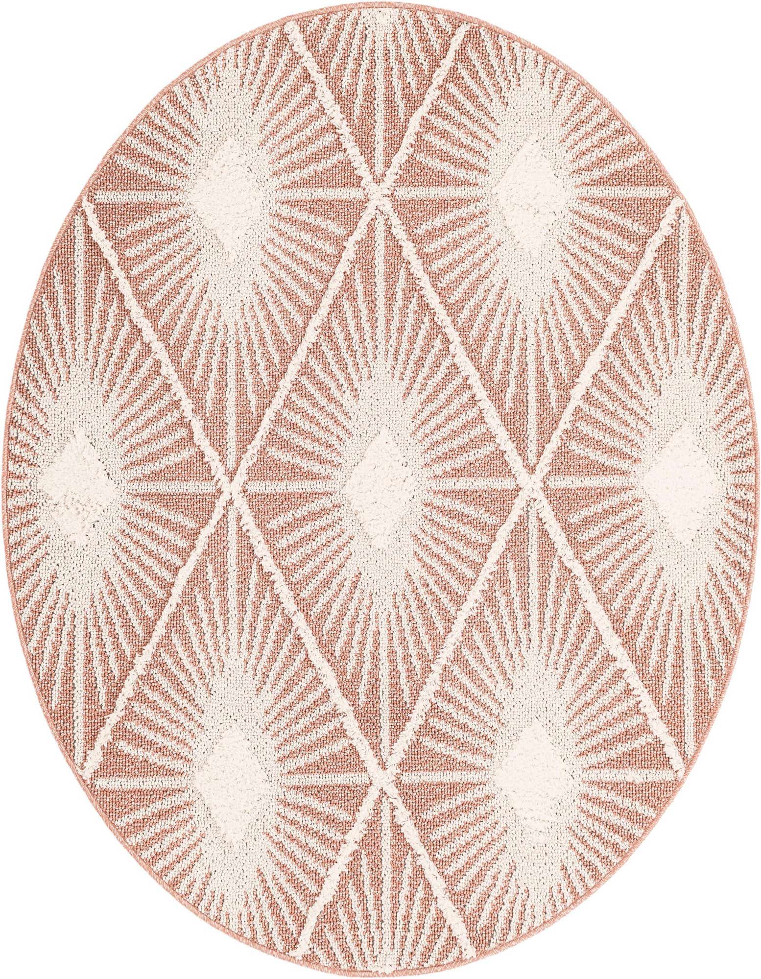 A 5' 3 round pink and white bohemian rug with a modern trellis pattern featuring sunburst designs.