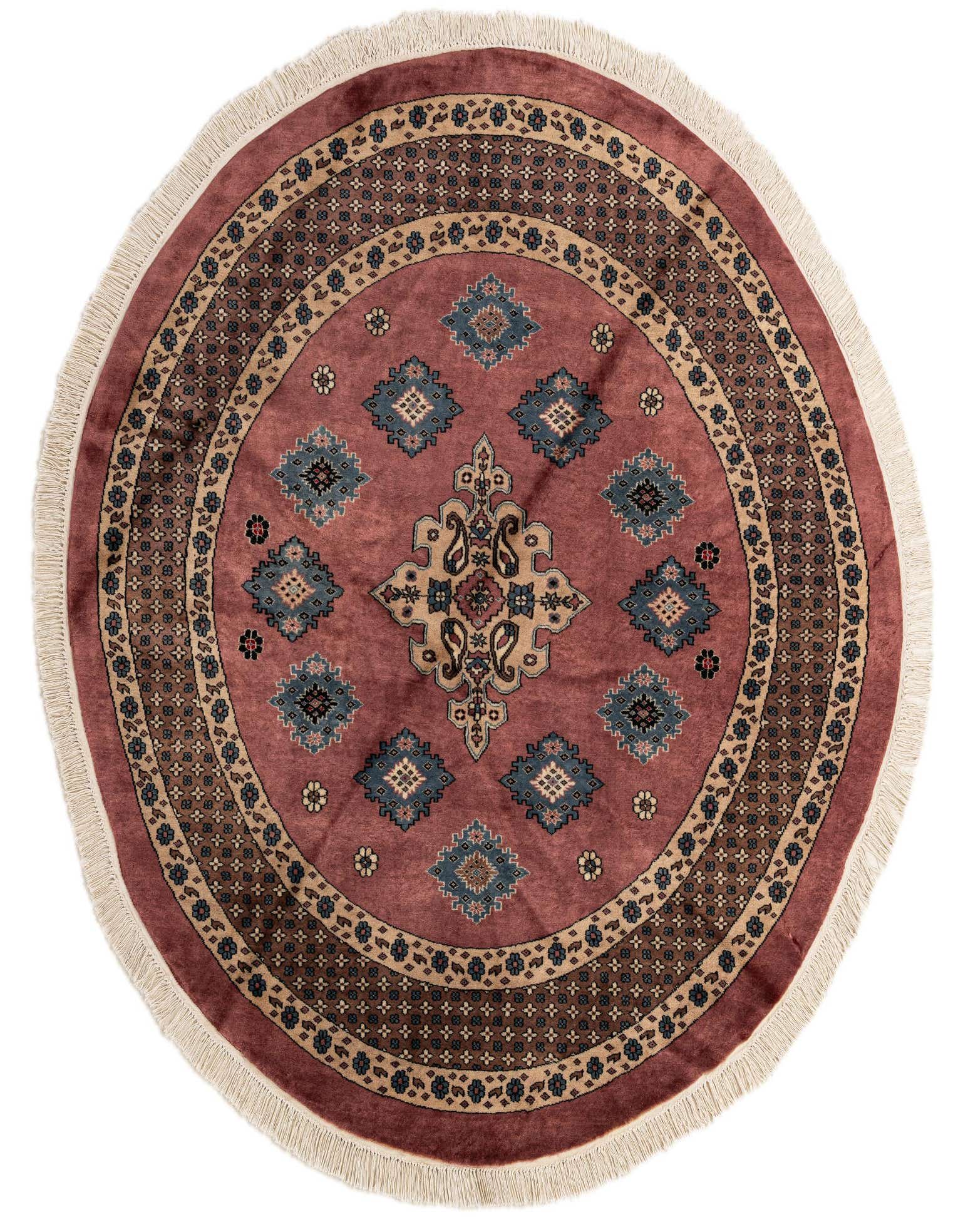 A 5' 11 x 6' 0 round pink wool rug with a traditional tribal medallion pattern and fringe.