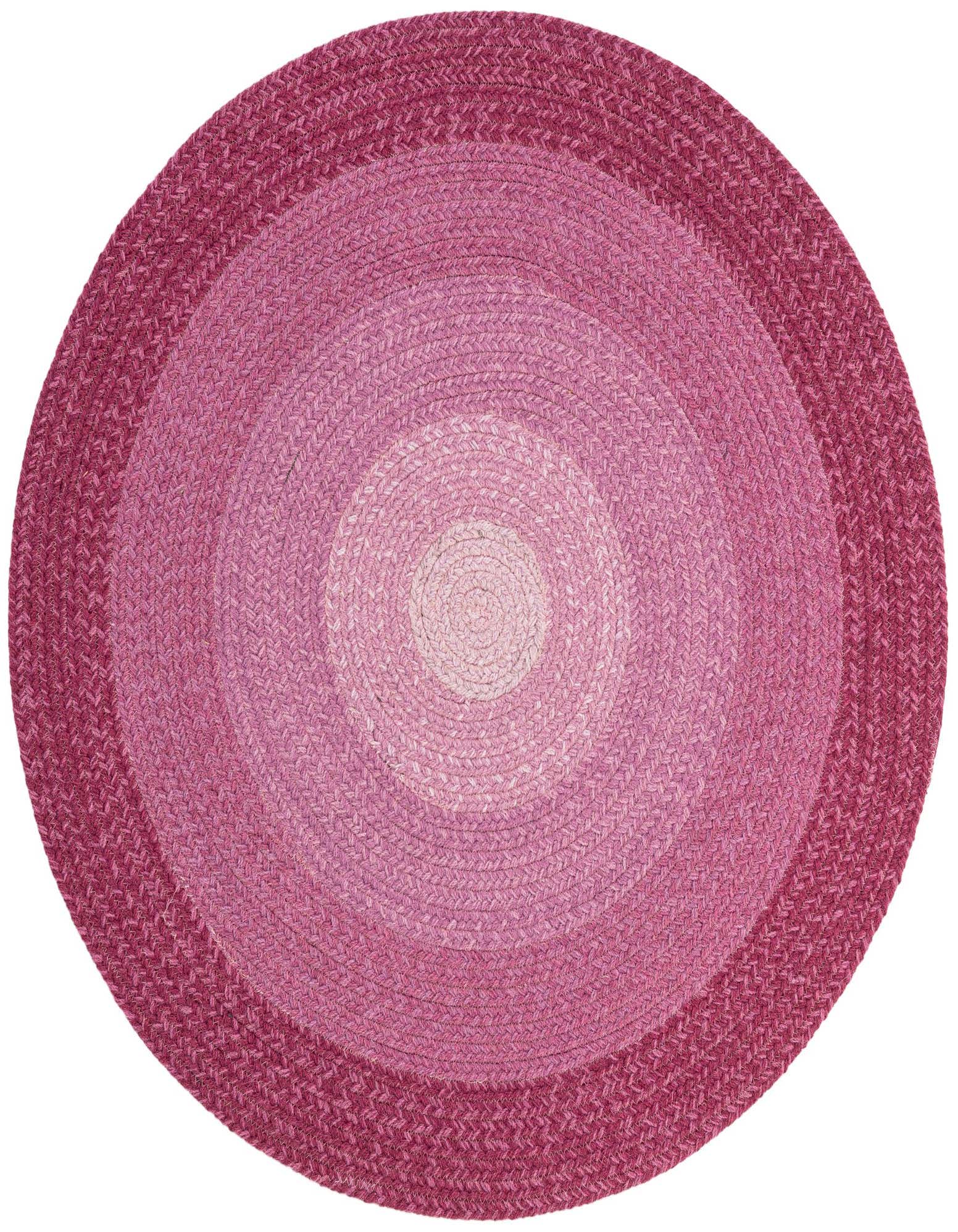 A round, hand-braided wool rug in varying shades of pink, from light blush in the center to deep fuchsia at the edge, showcasing a modern, concentric design.