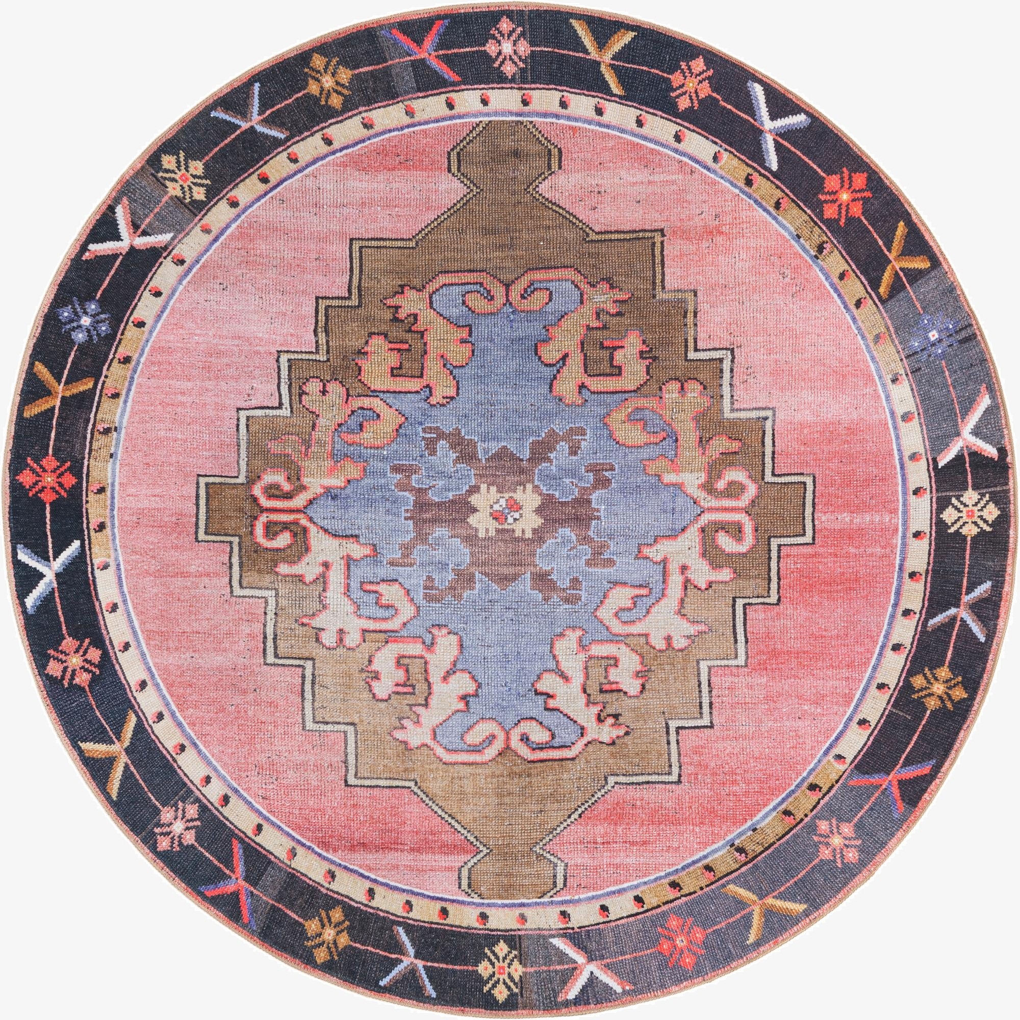 A 7' 7 x 7' 7 round pink vintage rug with a central blue and brown medallion, surrounded by a dark border with geometric patterns.