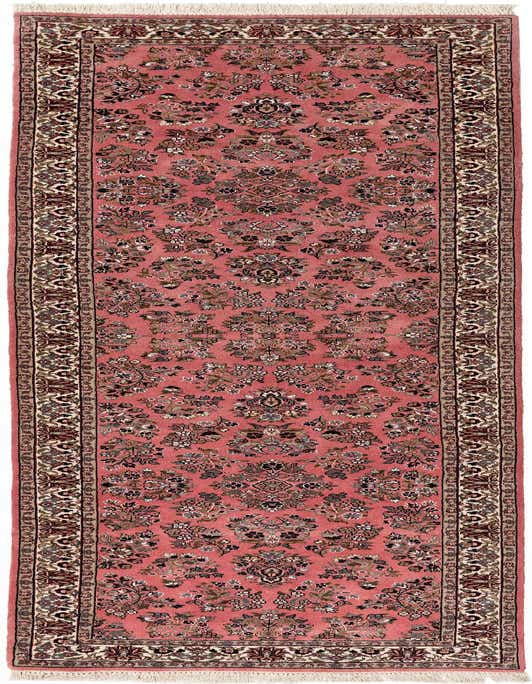 A pink 11 ft runner rug with an intricate oriental floral pattern and fringed ends, ideal for a hallway.
