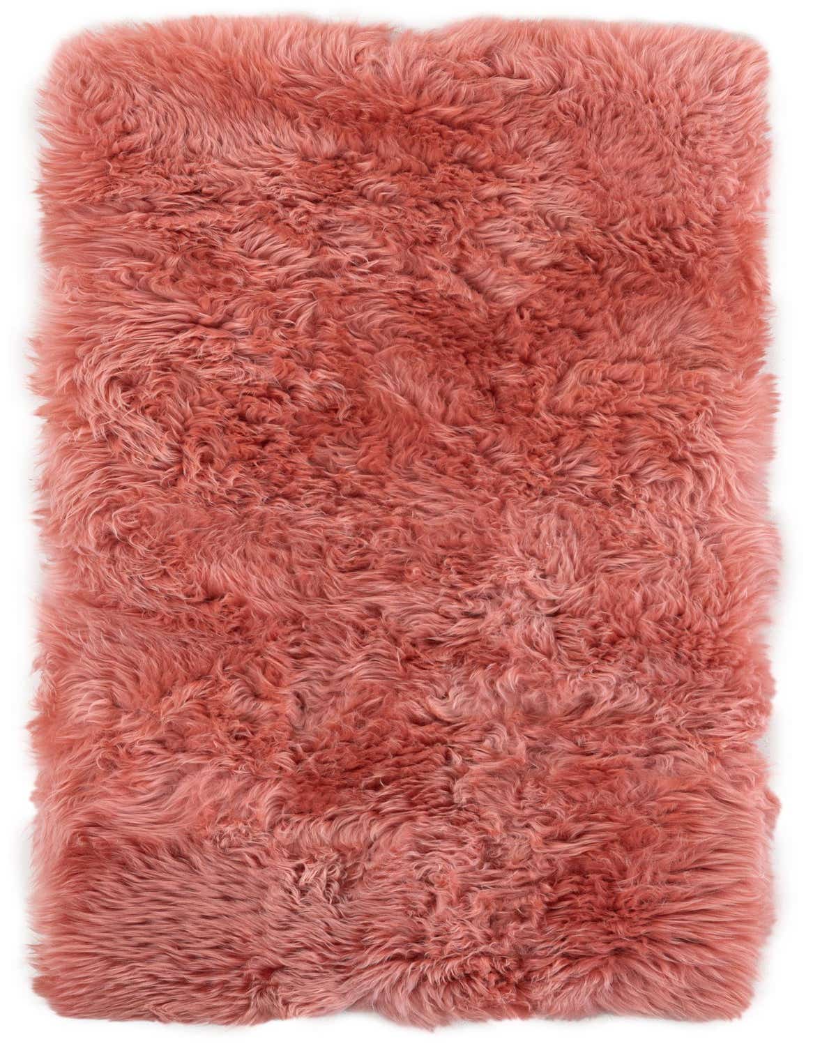 A plush, rectangular 4 ft pink lambskin runner rug with a medium, shaggy pile, perfect for a hallway.