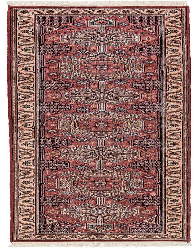 A 10 ft runner rug in pinks and black with a traditional tribal pattern, ideal for a hallway.