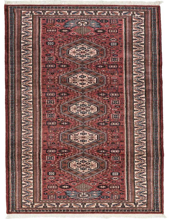 A 10 Ft runner rug in pinks with a traditional tribal pattern featuring geometric medallions and intricate borders, ideal for a hallway.