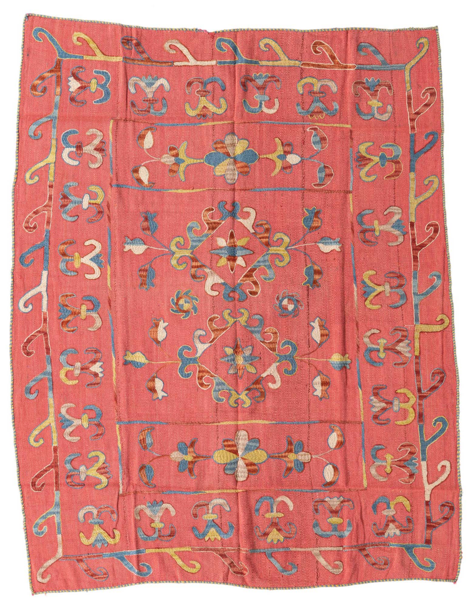 A 5' 3 x 6' 2 square pink Kilim Suzani rug with a tribal, oriental pattern in blue, yellow, and brown.