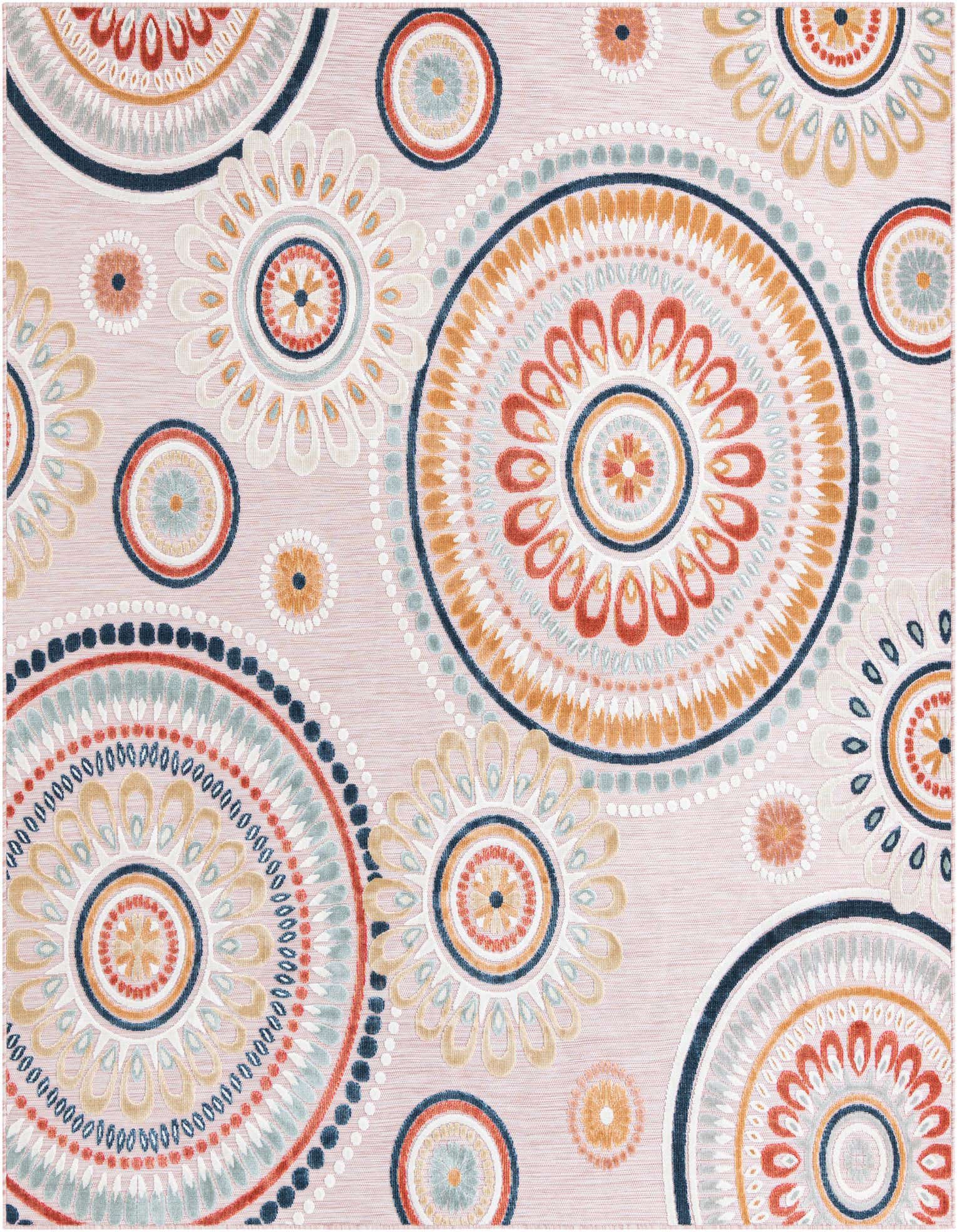 A square pink outdoor rug featuring large, colorful abstract floral medallions in orange, blue, and white.