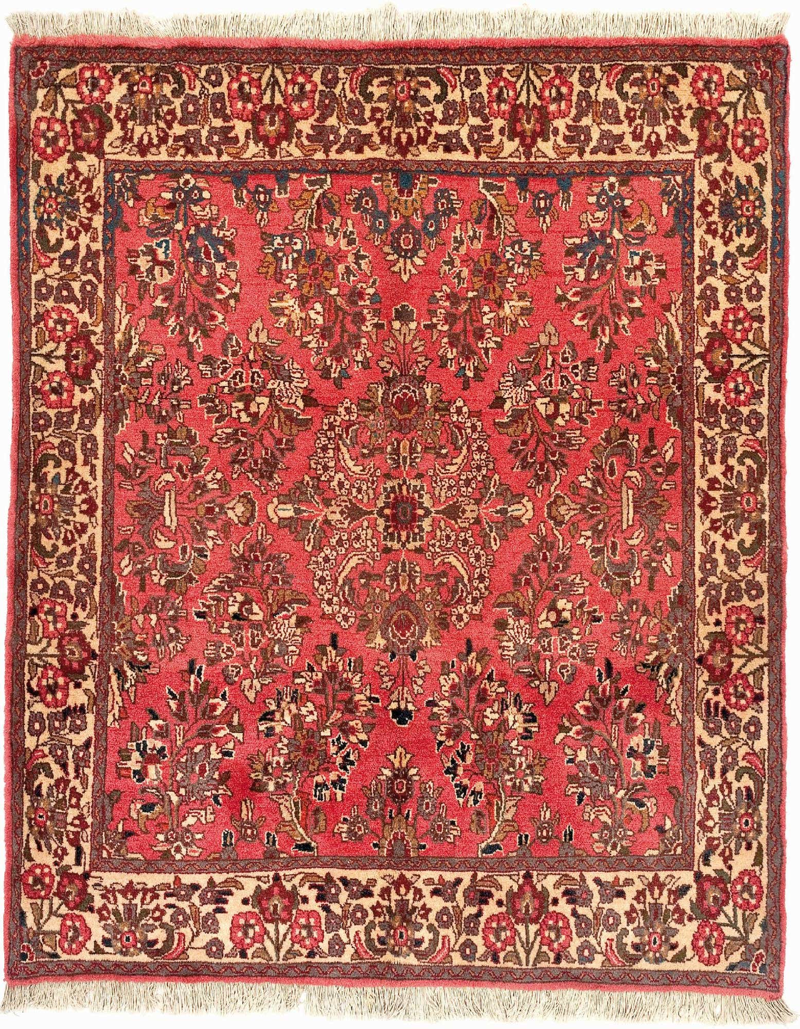 A square, handmade pink wool rug with an intricate traditional floral pattern and a light-colored border.