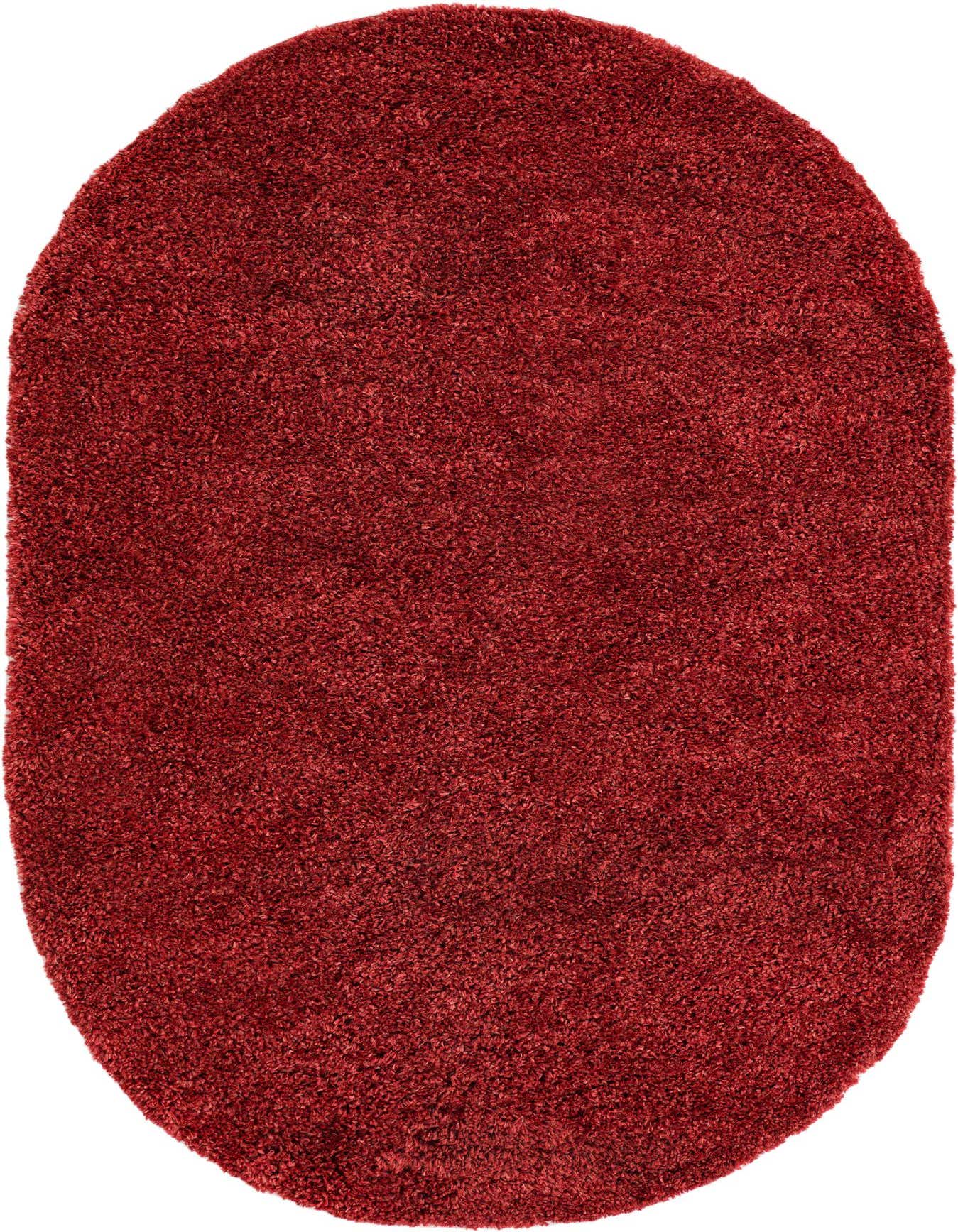 A plush, oval 5' 3 x 8' 0 red shag rug, showcasing its deep, textured pile and rich color.