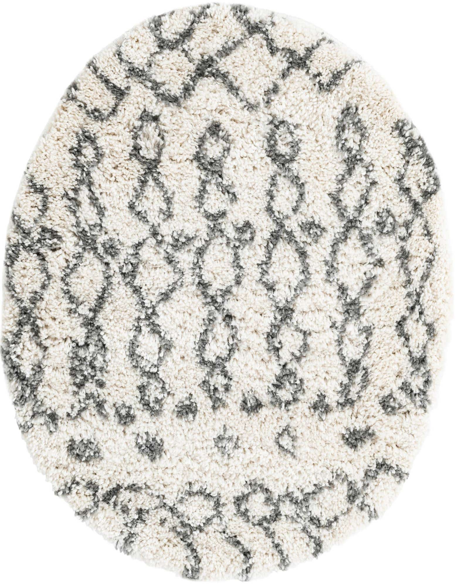 A round ivory shag rug with a modern tribal trellis pattern in dark gray, offering a soft texture.
