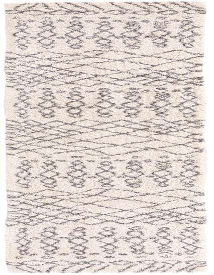 A 16 ft runner rug featuring a plush ivory shag pile with a modern tribal trellis pattern in dark gray.