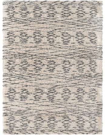 A 20 ft runner rug in ivory and cream with a dark tribal trellis pattern, featuring a plush shag pile.