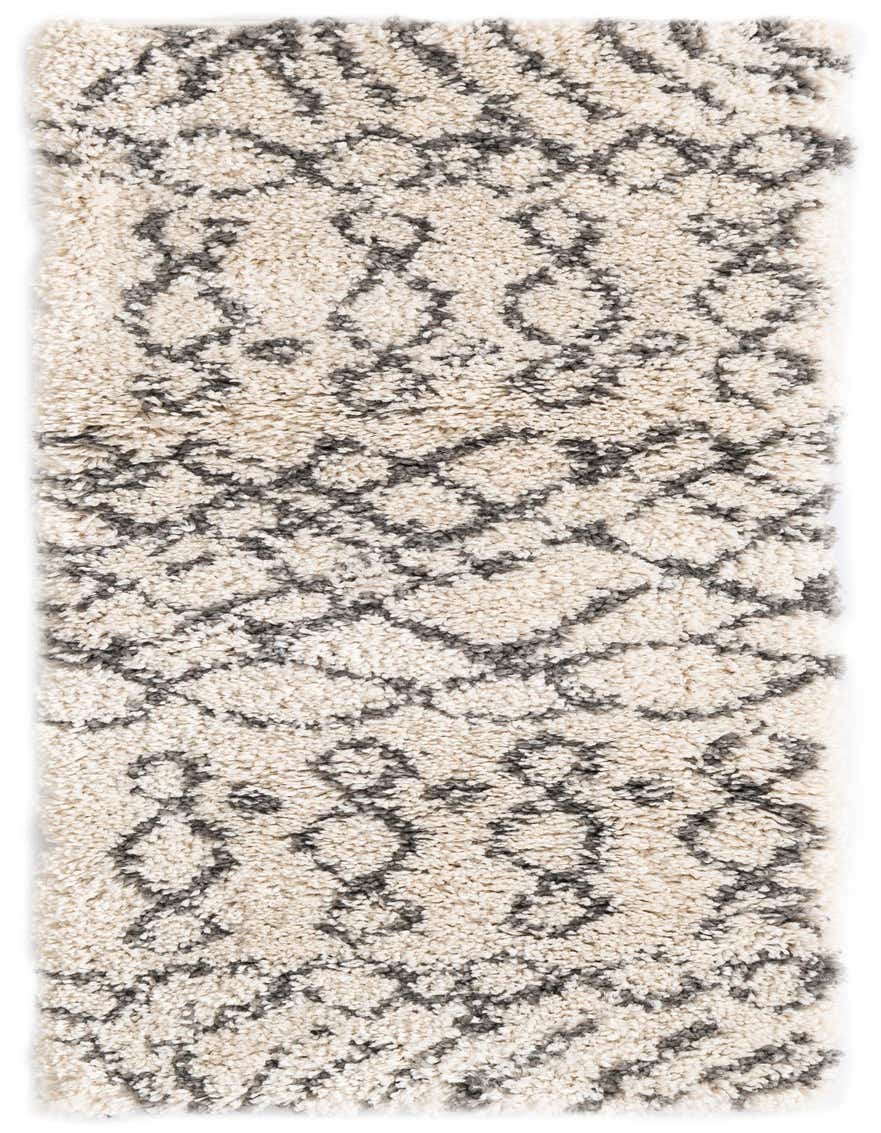 A 5 ft runner rug with a thick, shaggy pile in ivory and cream, featuring a modern geometric pattern in charcoal gray.