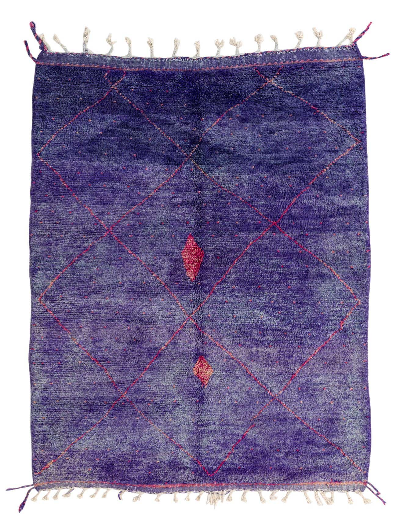 A 5x8 rectangular purple shag rug with a red tribal diamond pattern and white tassels on a white background.